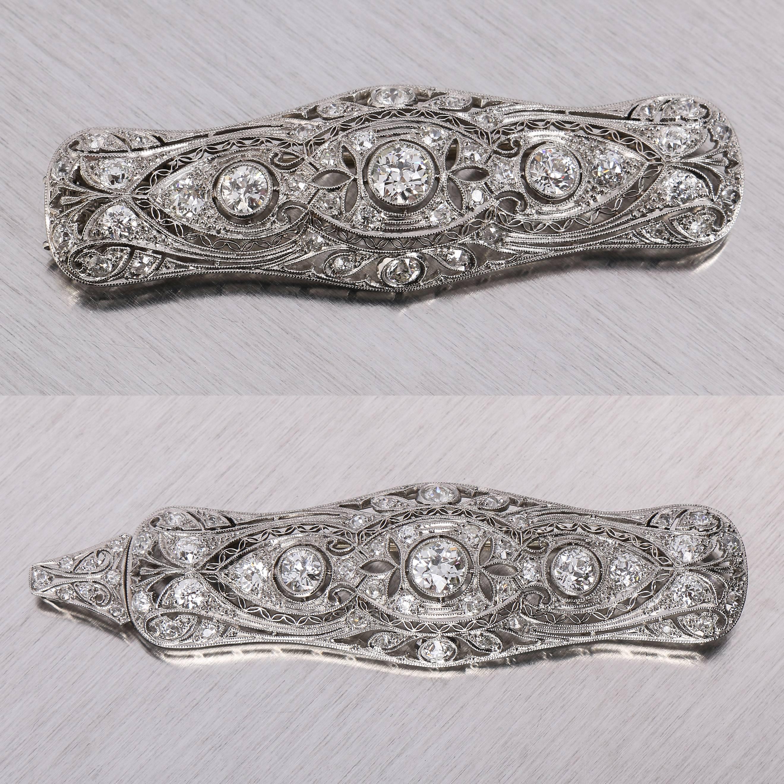 Antique Gregorian c.1915 platinum diamond bar pin pendant. Features three Old European cut diamonds at center of pin. Diamond in center is estimated to be approximately .50 ct, graded as G/SI2. Two diamonds on either side of center diamond are