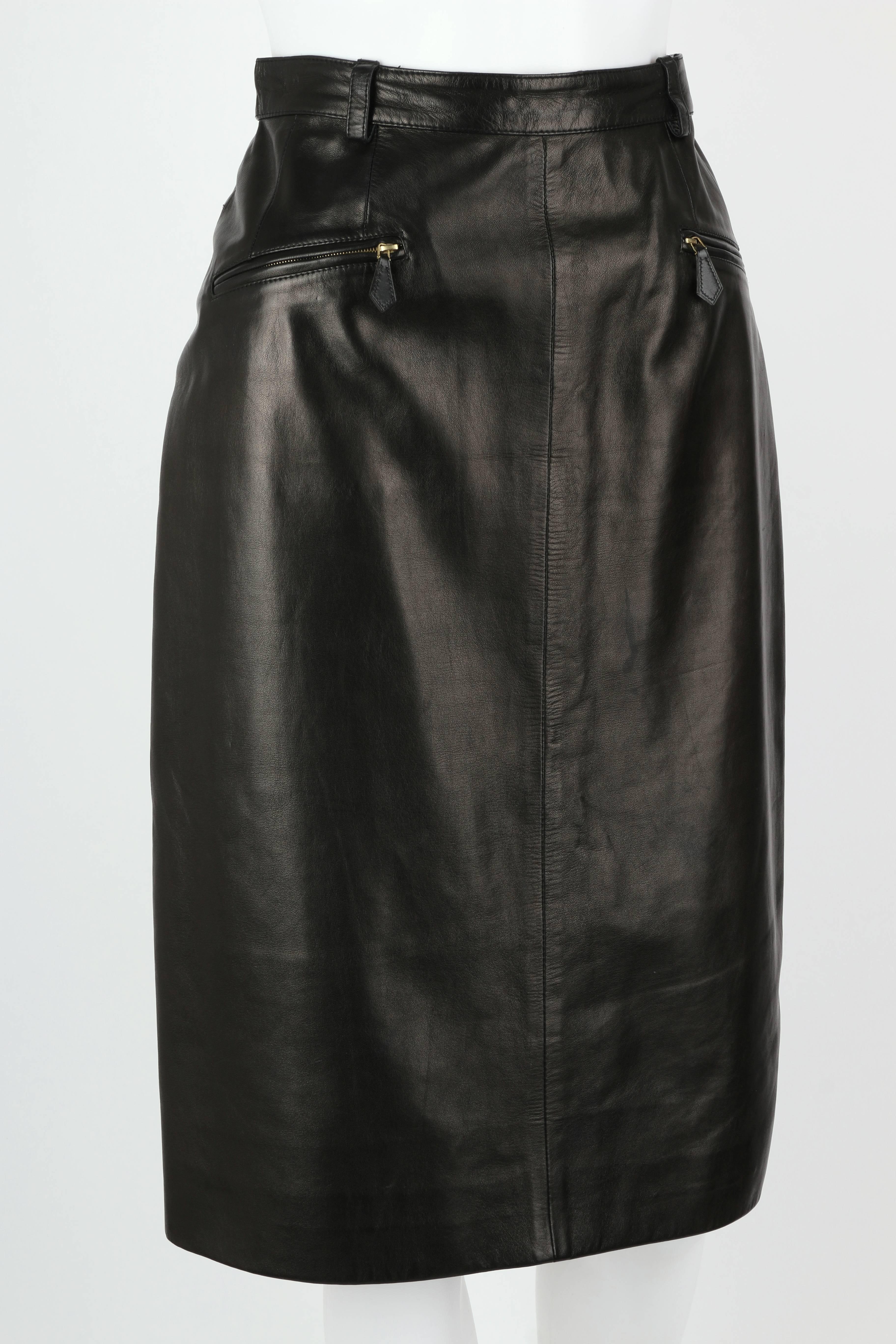 Vintage c.1990's Hermes black genuine lambskin leather pencil skirt. Two front zipper pockets. Belt loops around waist. Hidden zipper and button closure at hip. Back kick pleat. Above the knee length. Fully lined. Please note this item was pinned to