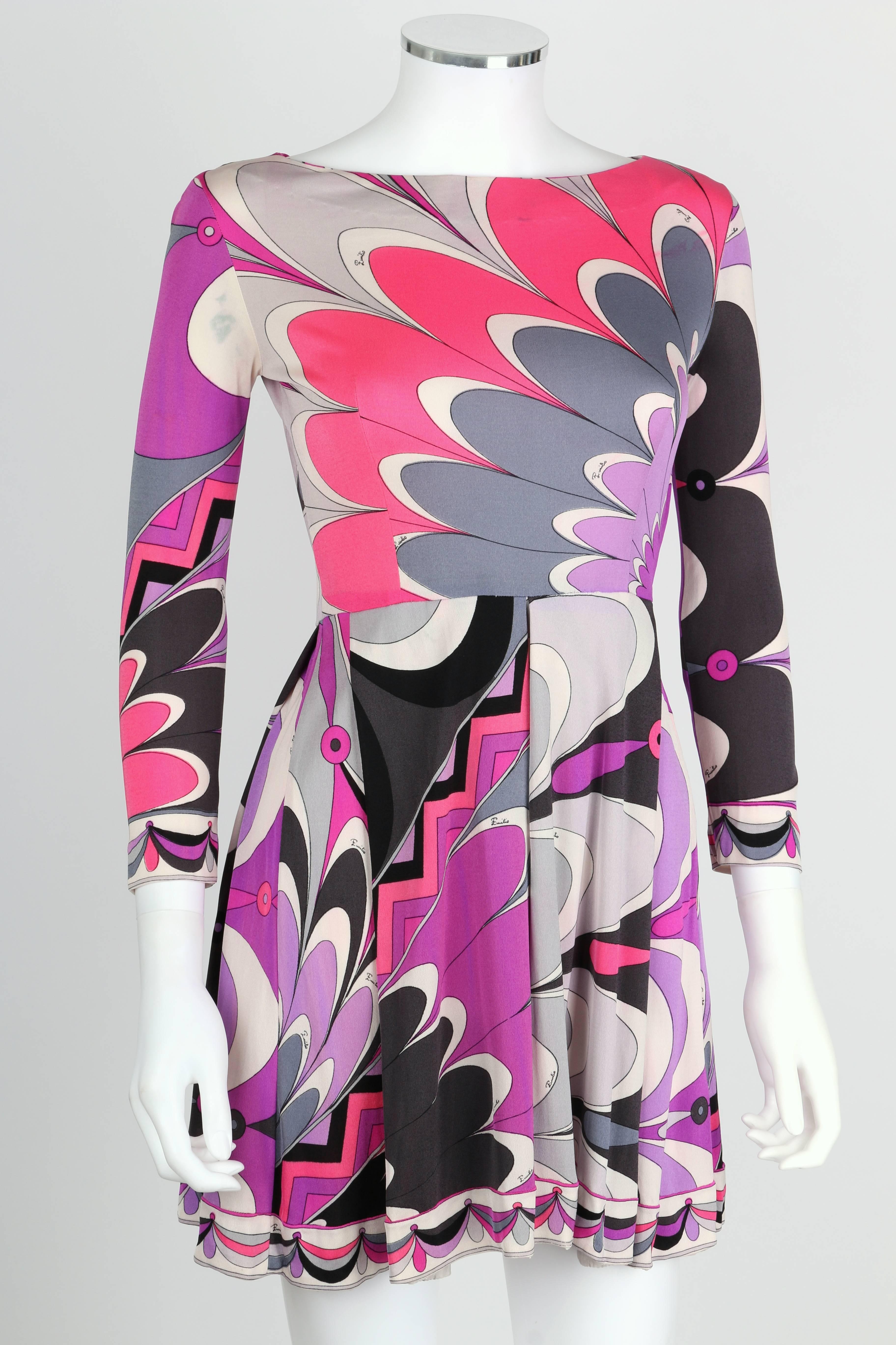 Vintage c.1960's Emilio Pucci abstract sunburst floral signature print in shades of purple, gray, black and pink silk jersey dress . Bateau neckline. 3/4 length sleeves. Skirt has large center box pleat. Side zipper closure. Marked Fabric Content: