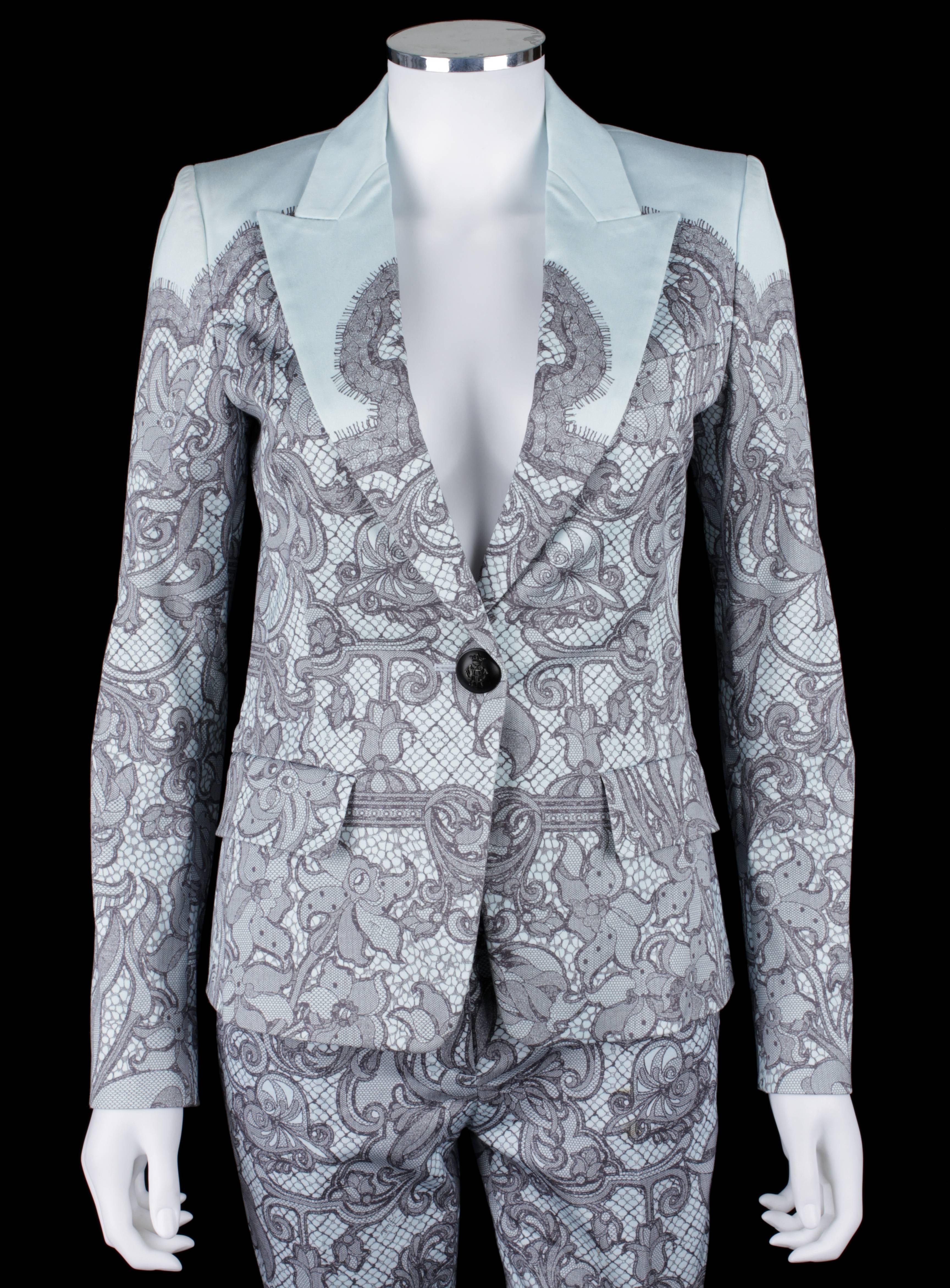 Emilio Pucci two piece pale blue lace print pantsuit. Blazer has a single front button closure. Three button detail on cuffs. Two flap pockets and one faux pocket at chest (original stitching has not yet been removed). Peak lapel. Padded shoulders.