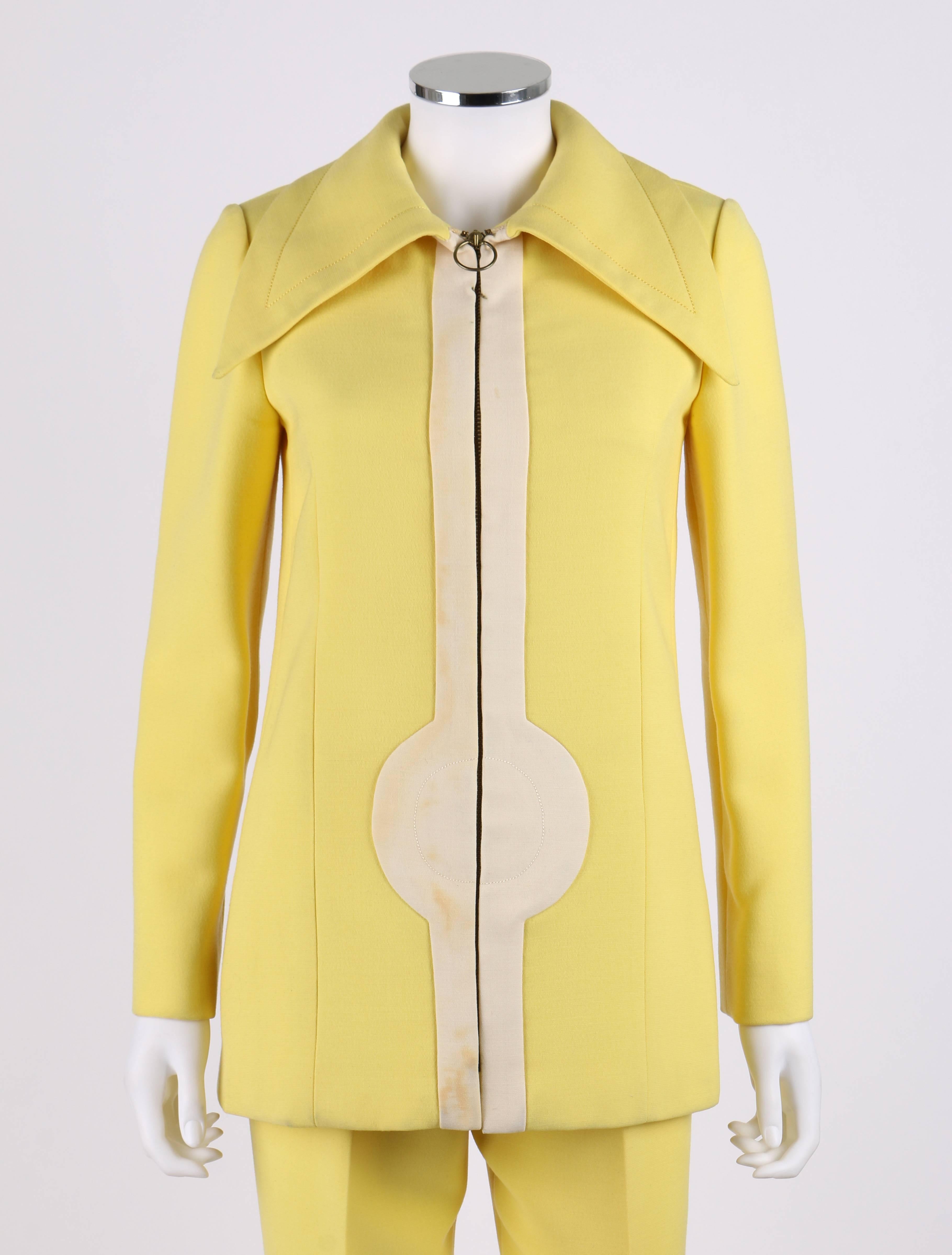Vintage c.1960's Pierre Cardin two piece yellow and cream zip front jacket and pants suit set. Yellow jacket has signature pop art inspired white detail down center front zipper closure. Large spread collar. Long sleeves. Two hip pockets. Double