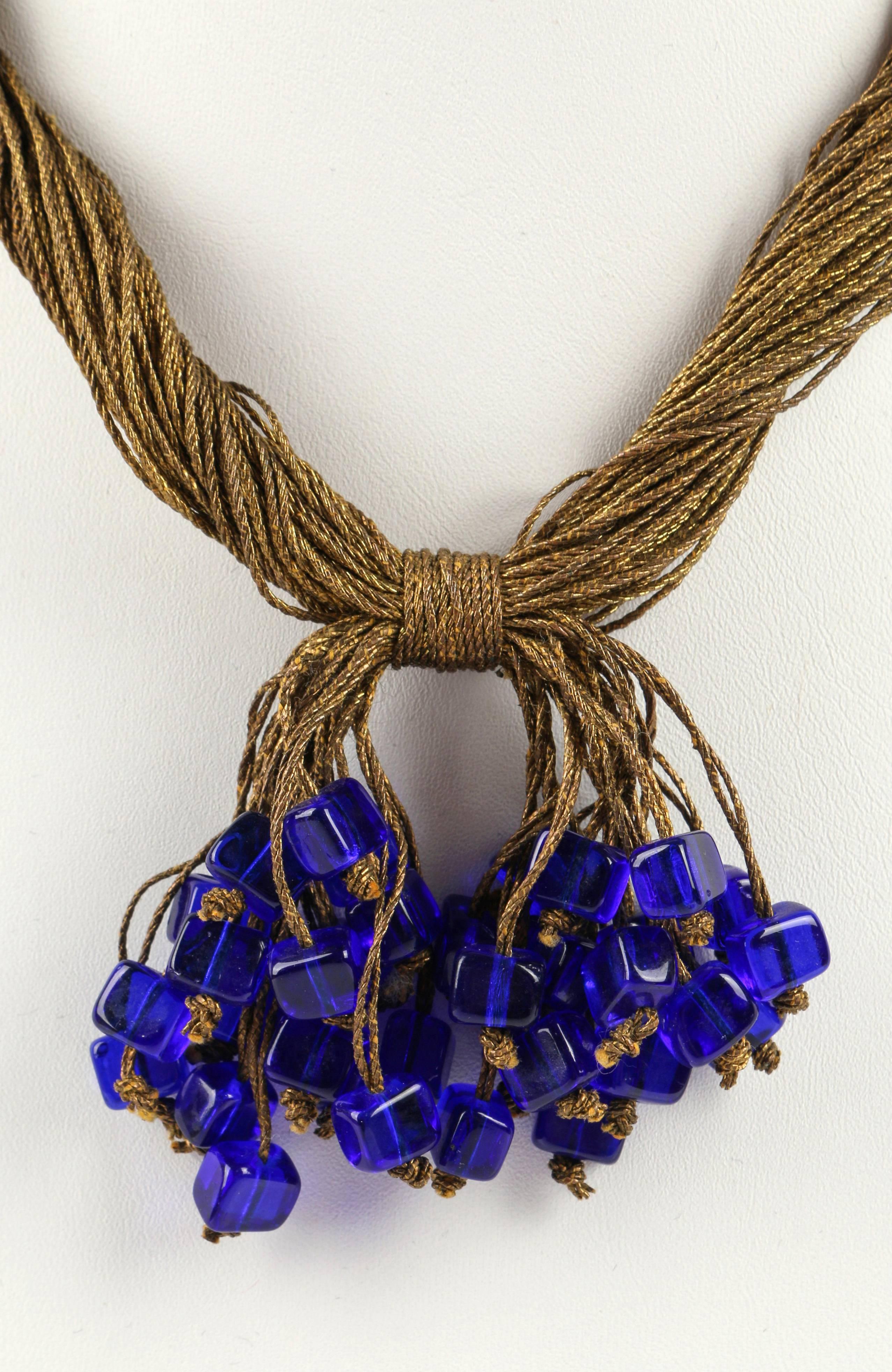 Vintage c.1920's antique gold toned bullion tassel and multi thread necklace with cobalt glass bead dangles. Necklace is made of several twisted bullion threads (fine brass tone metal wrapped thread). Threads bound at center front of necklace to