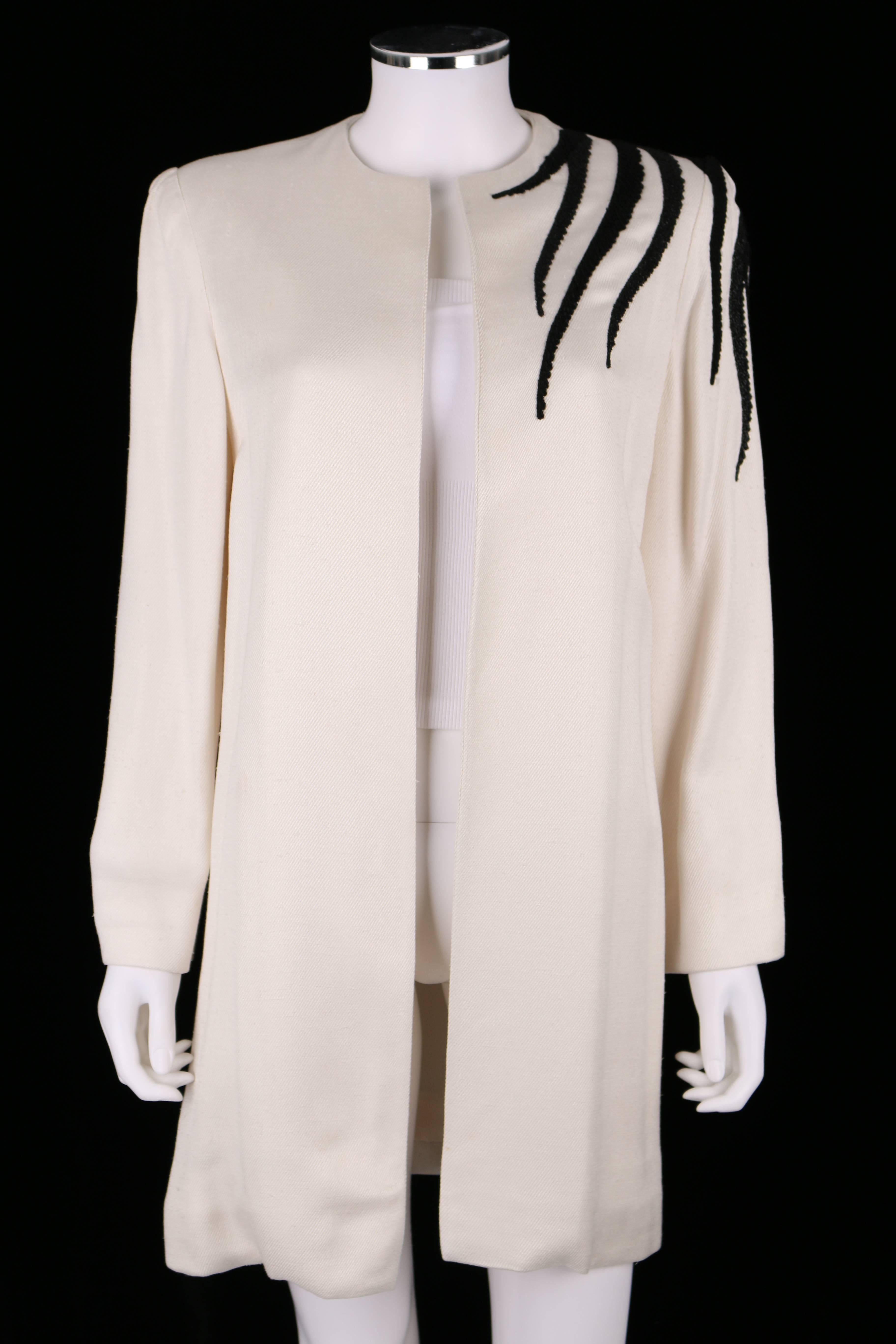 Vintage c.1980's Bob Mackie I. Magnin ivory silk twill long blazer jacket. Cord and beaded black roaster embellishment on back continuing onto left front shoulder. Long sleeve. Collarless. Open front. Padded shoulders. Fully lined. A tube top was