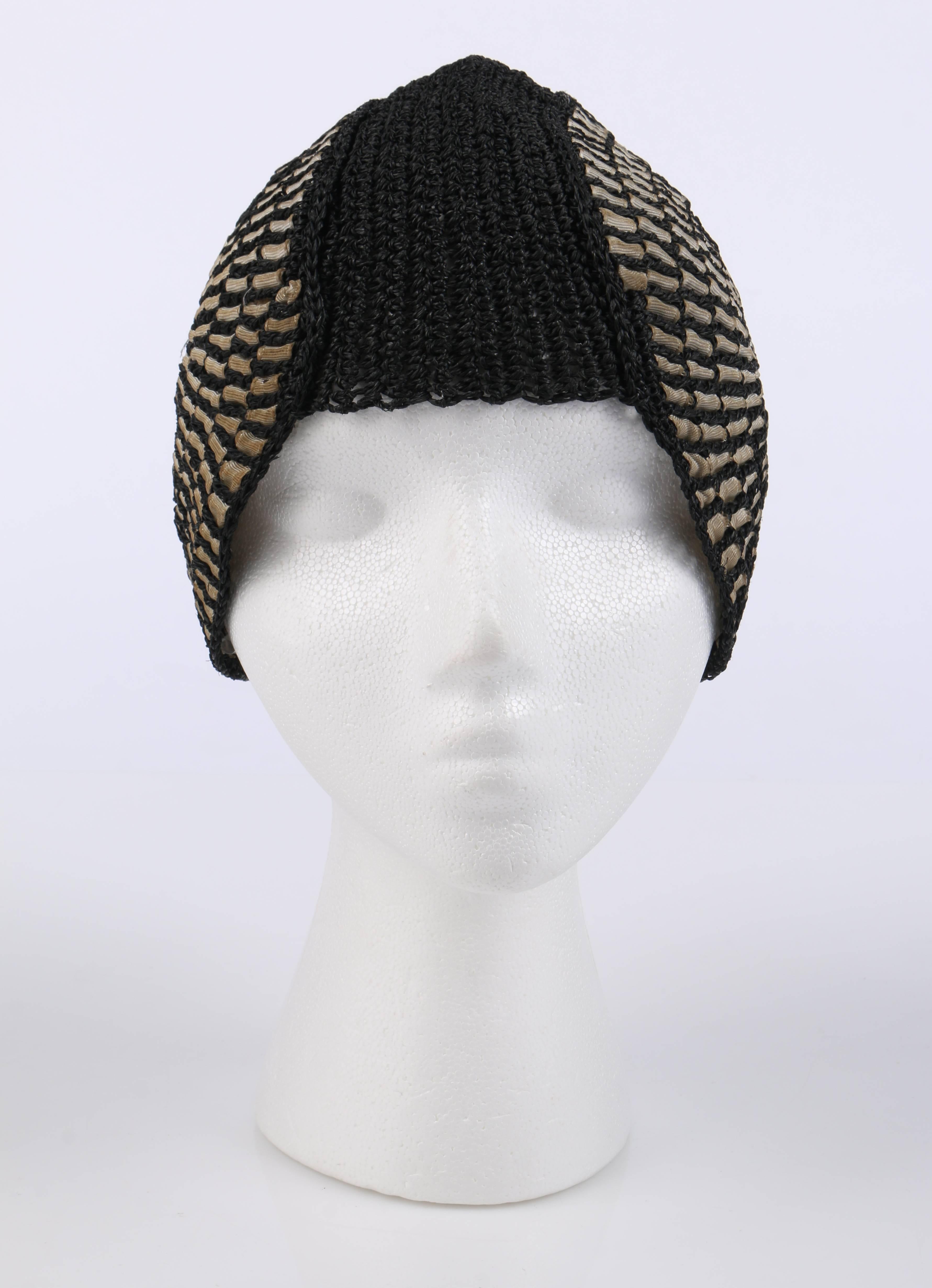 Vintage c.1920's black crocheted straw woven detail Juliet cap cloche hat. Black crocheted straw body. Beige grosgrain ribbon woven in a spiral pattern on either temple. Helmet style formed around the head. Unlined. Unmarked Fabric Content: Straw.