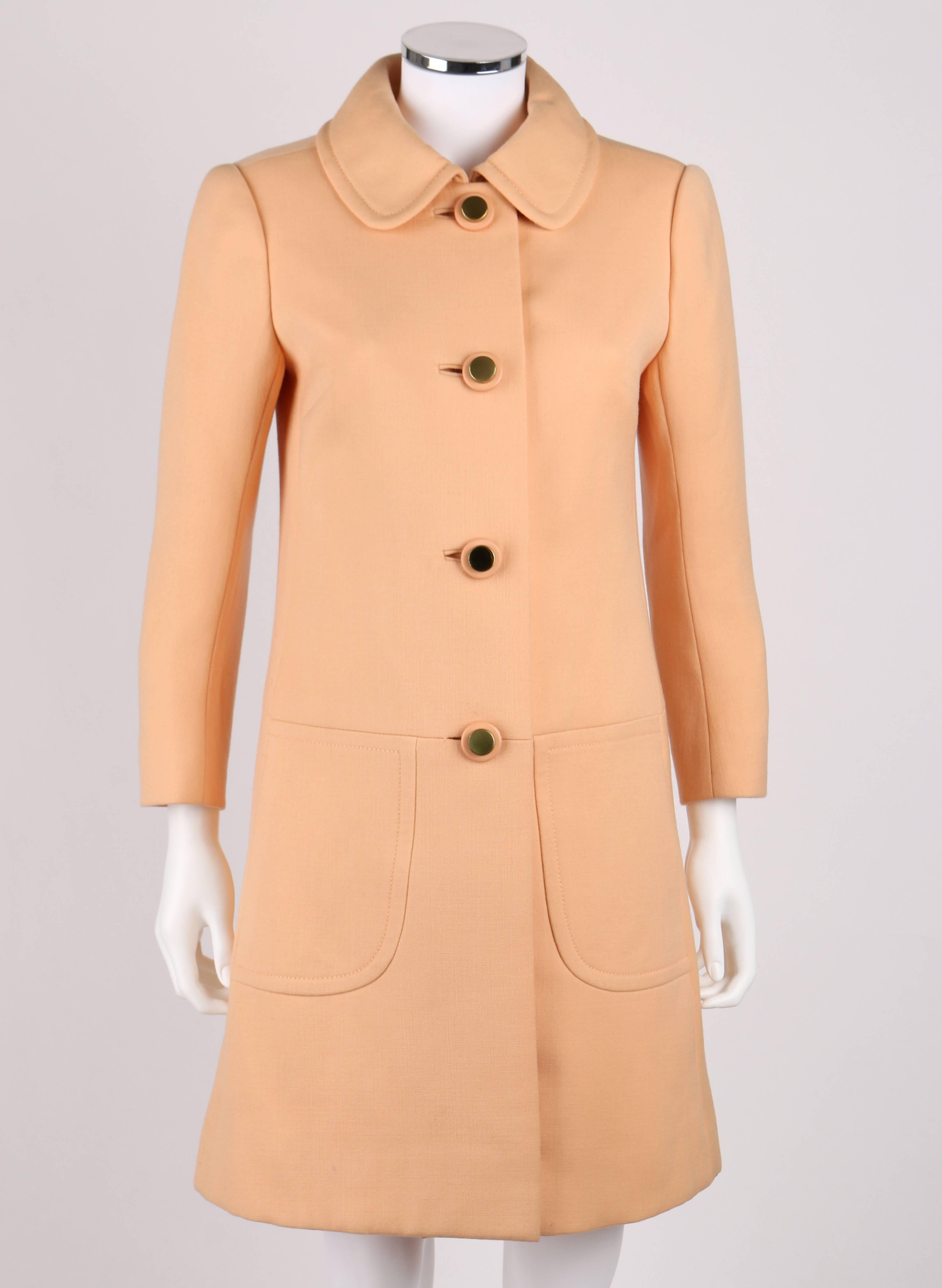 Vintage Diorling By Christian Dior c.1960's peach 100% wool coat. Peter pan collar. Two front rounded inseam pockets. Four center front button closures. Round three dimensional gold and peach buttons. Princess seams. Fully lined. Marked Fabric