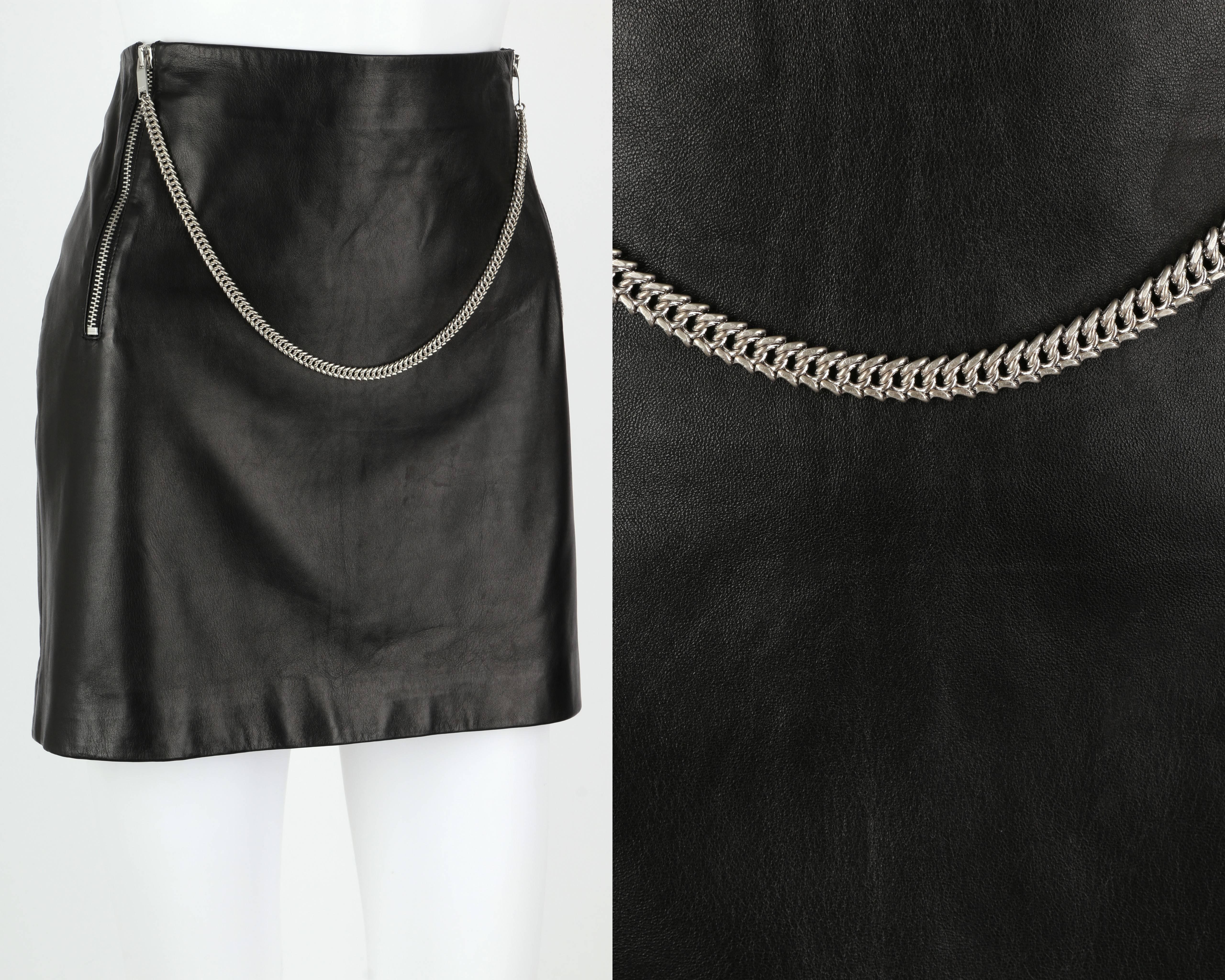 Saint Laurent black lambskin leather mini skirt. Two vertical silver-tone zippers in front. Curb link silver-tone chain draped between zipper pull tabs. Pull tabs embossed 