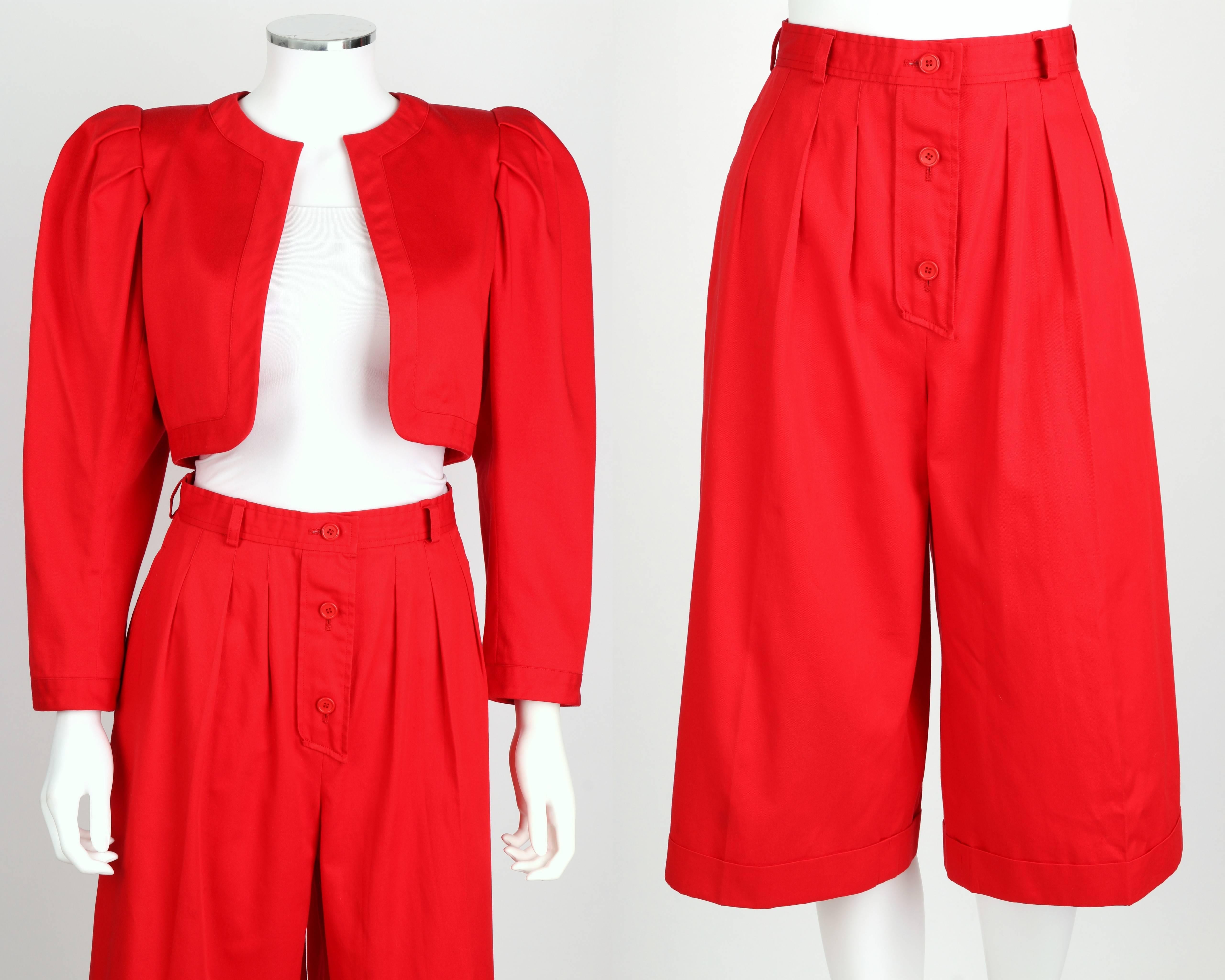 Yves Saint Laurent c.1980's Rive Gauche pant set. Red bolero jacket. Puff sleeves with shoulder pads. Lined. Matching high waisted gaucho pants. Five belt loops. Three button and hook front closure. Pleats in front and back. Fold-over cuffs. Marked