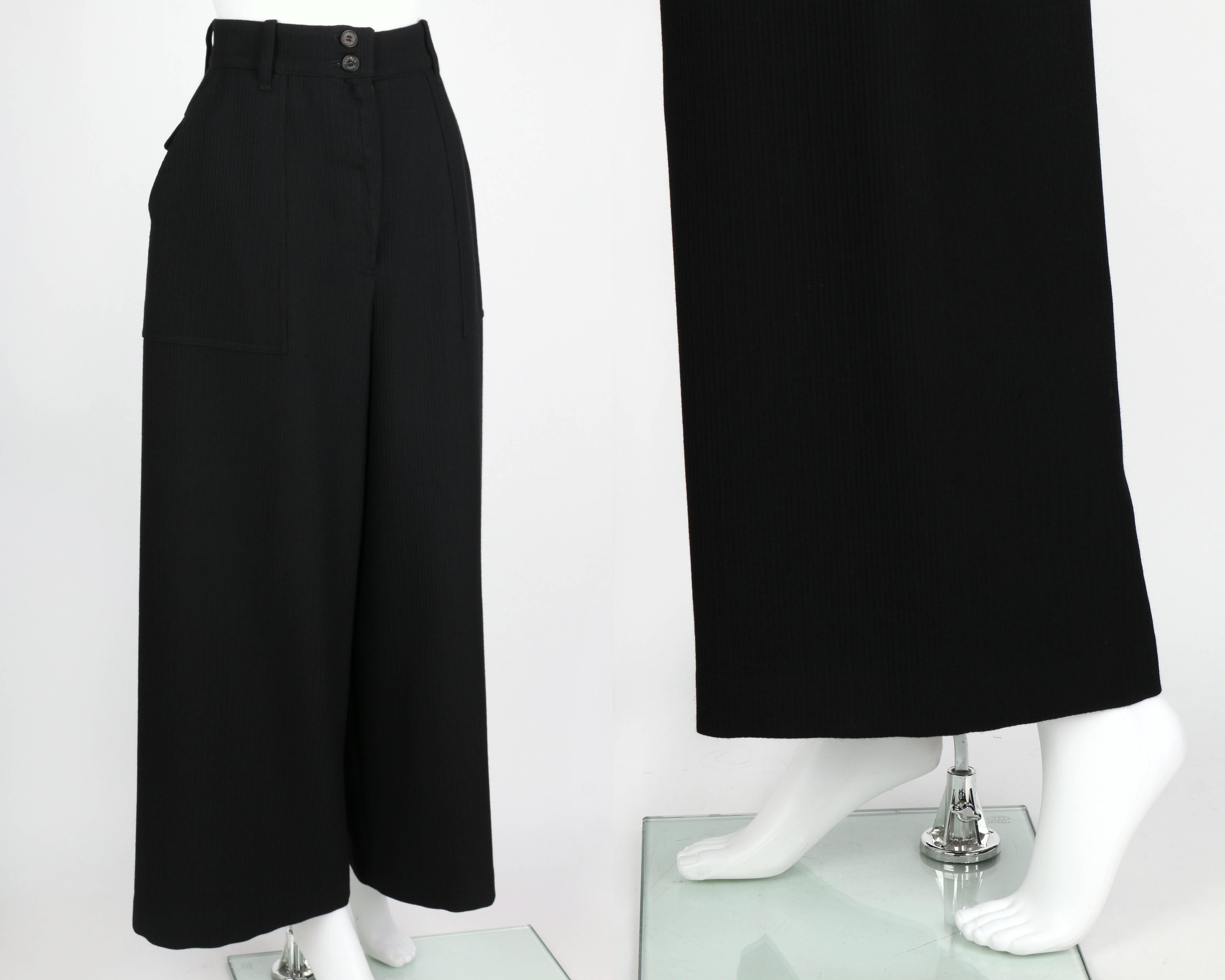 Hermes c.1990's classic black wool wide leg pants. Ribbed herringbone wool. High waisted. Five belt loops. Center front zip fly with two button closures at top. Two front large hip pockets. Two back patch pockets with flap. Partially lined. Legs