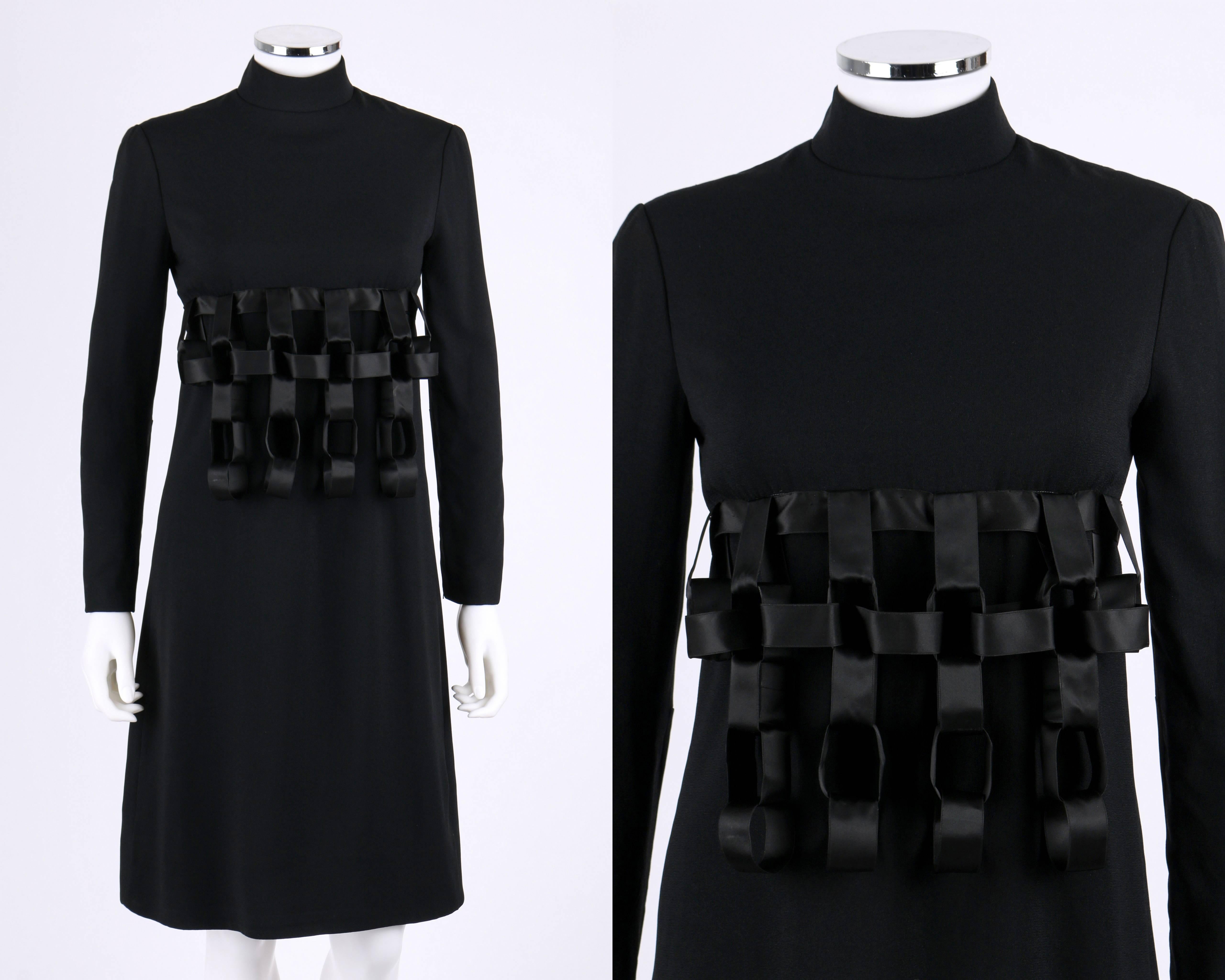 Geoffrey Beene c.1960's black wool architectural ribbon chain dress, originally sold at Dayton's Oval Room. Long sleeves. Mandarin collar. Empire waist. Three dimensional ribbon chain cage in front, ribbon tie in back. Back zipper closure with hook