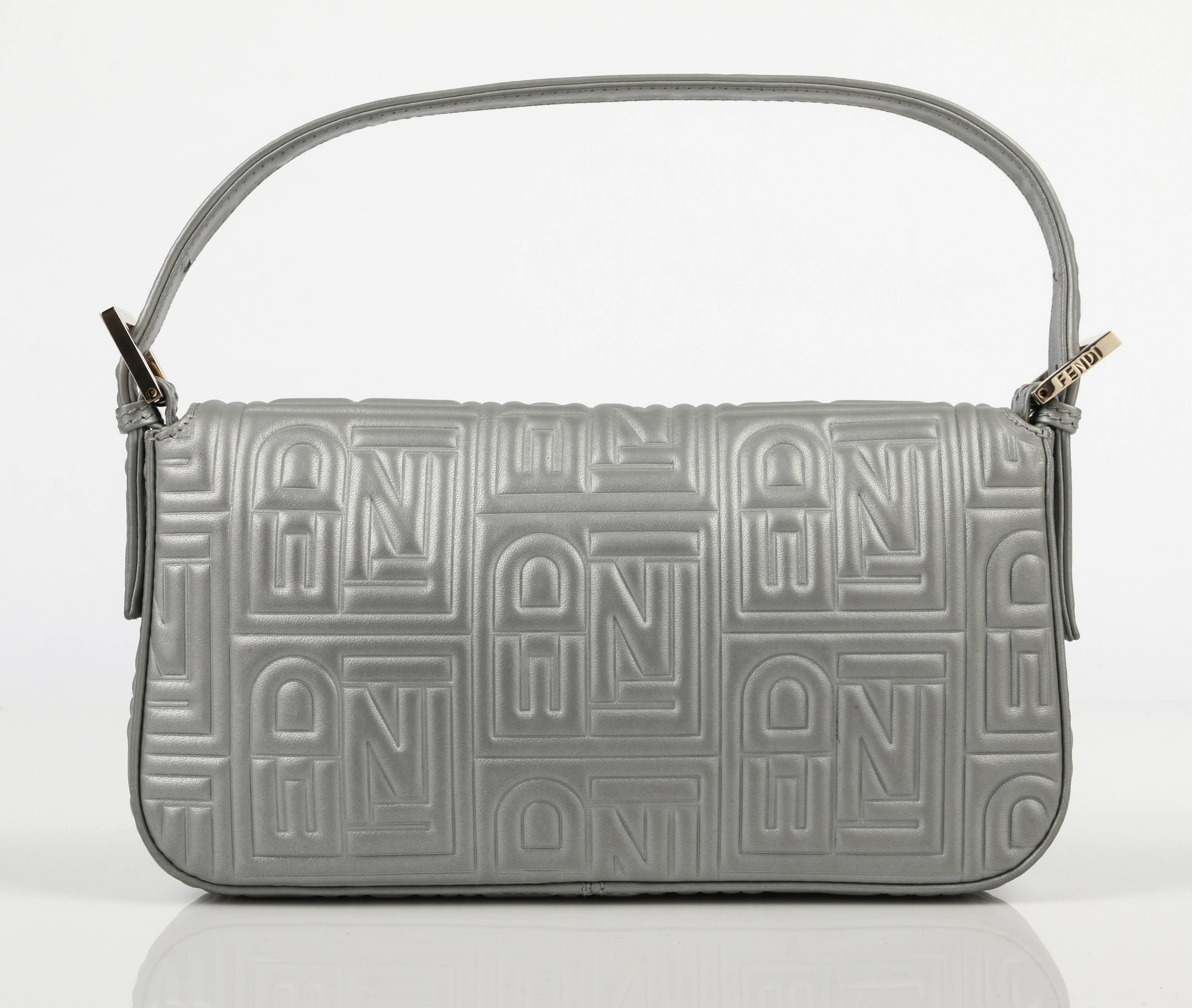 Fendi S/S 2010 metallic silver gray logo embossed leather baguette. Leather is embossed with signature "FENDI" throughout. Flap front with magnetic snap closure. Adjustable embossed leather strap. Gold-toned hardware. Multicolored cartoon