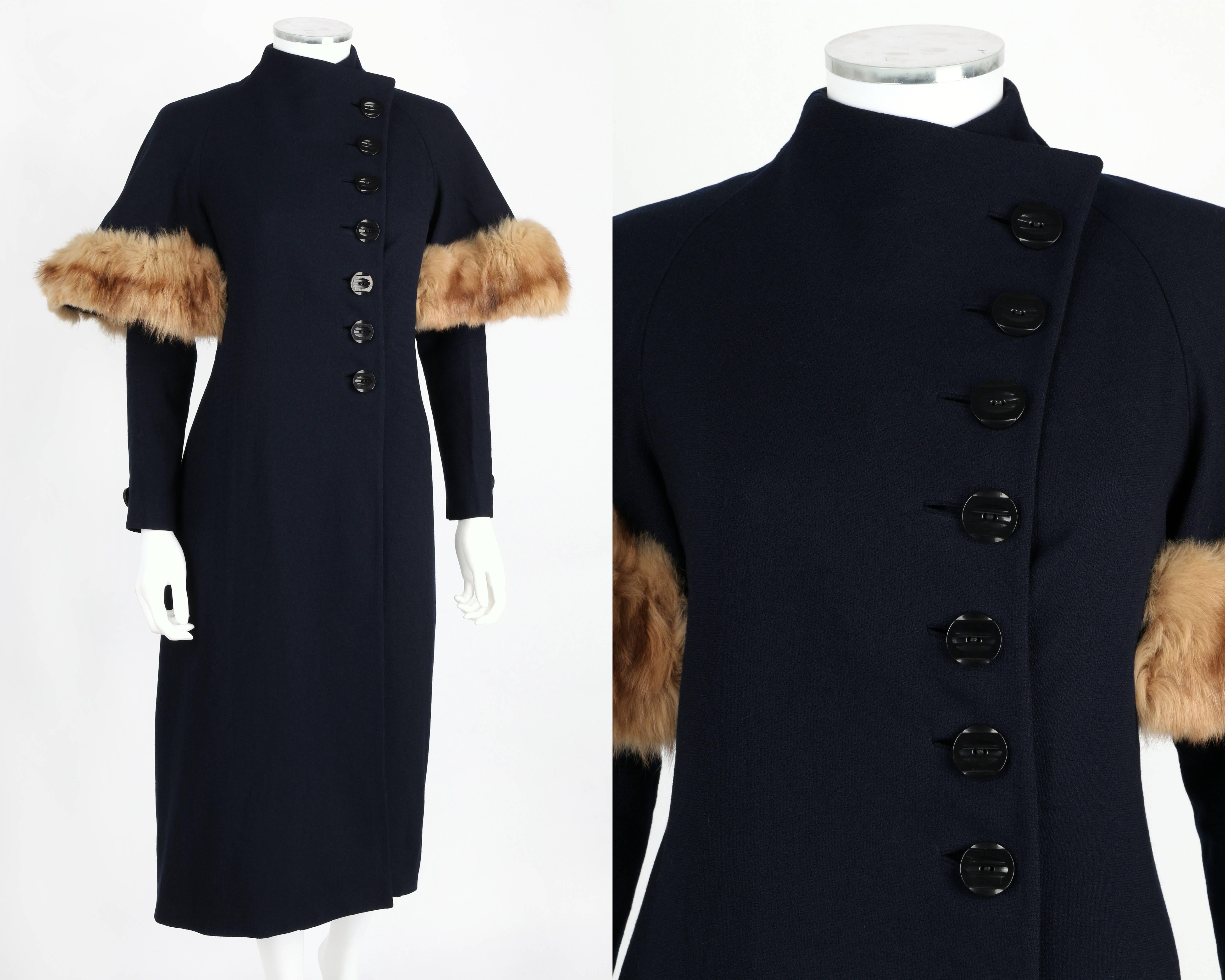 Vintage 1930's couture-made wool & fox fur trim coat. Long dolman sleeves with single-button detail at cuff. Genuine fox fur trim sleeve overlay. Asymmetrical front with seven-button closures. Built-up neckline. Fully lined. Interior tie and loop at