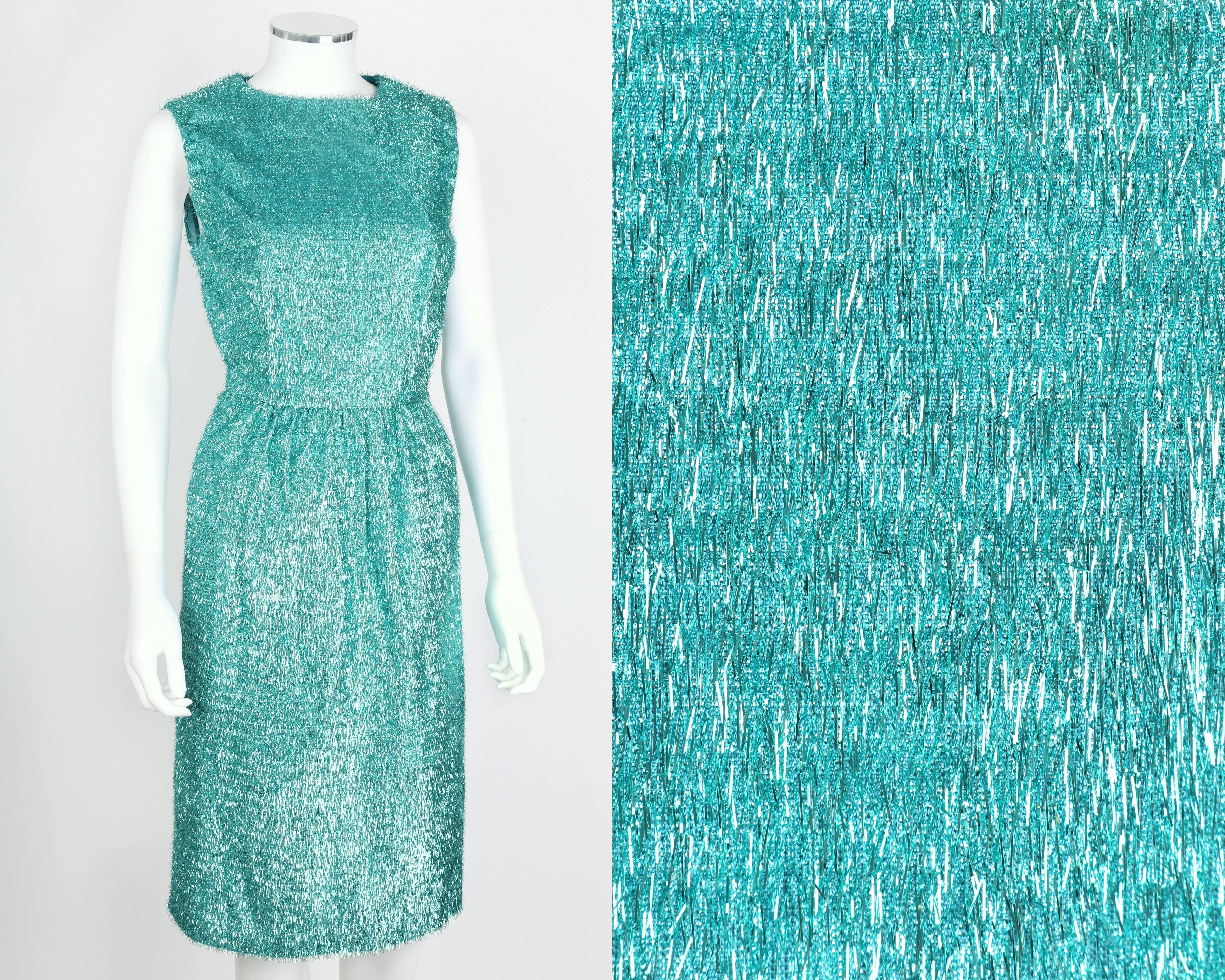 Vintage couture c.1960's turquoise blue metallic tinsel party dress. Shift style. Jewel neckline. Sleeveless. Center back zipper closure. Bust darts. Center back slit. Unlined. Please note this item was clipped to better fit our mannequin for