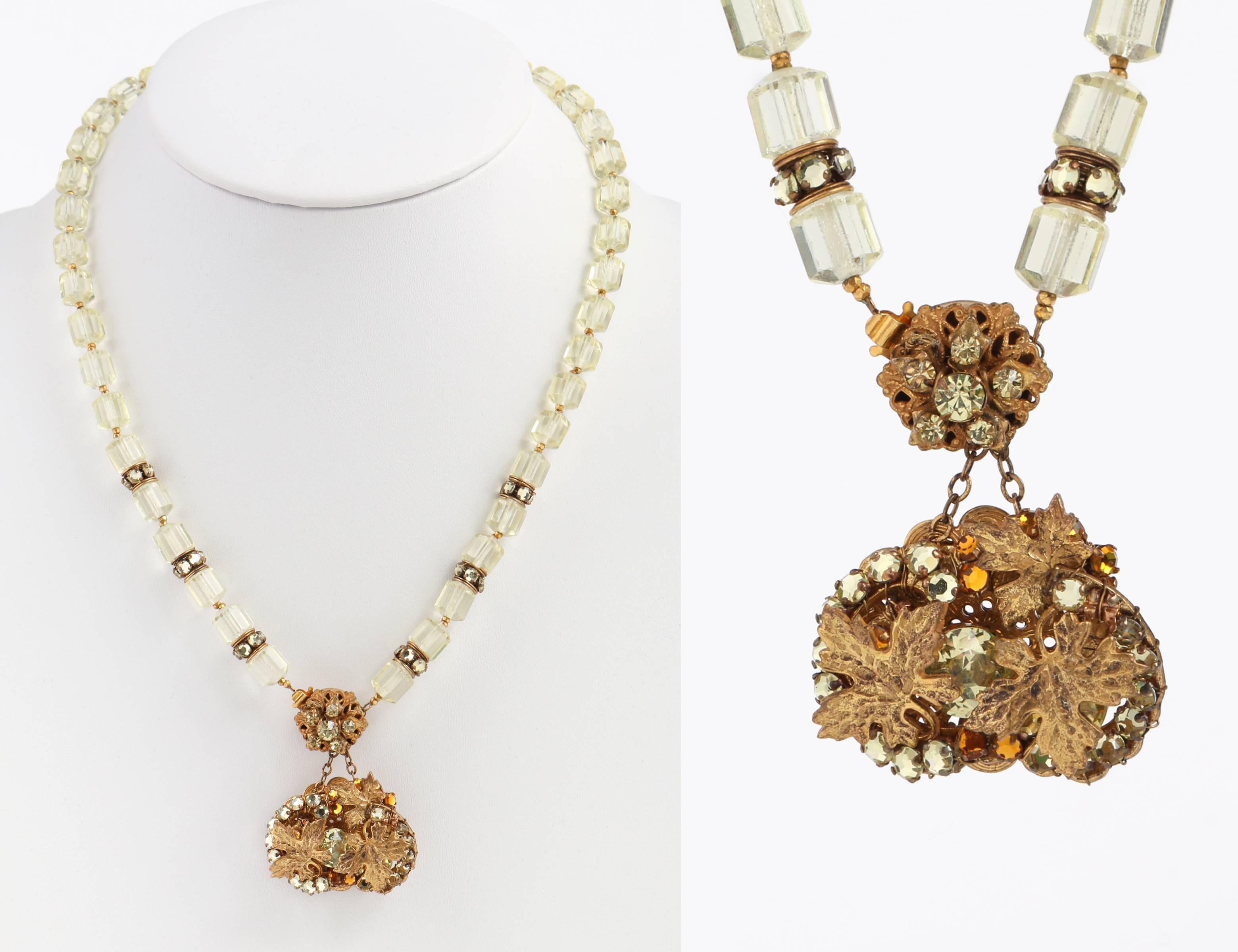 Vintage Miriam Haskell c.1950's gold gilt leaf crystal beads pendant necklace. Crystal clear (with a subtle hint of light green/yellow) cathedral barrel beads (measuring approximately 9 mm) which are linked together with two tiny faceted gold tone