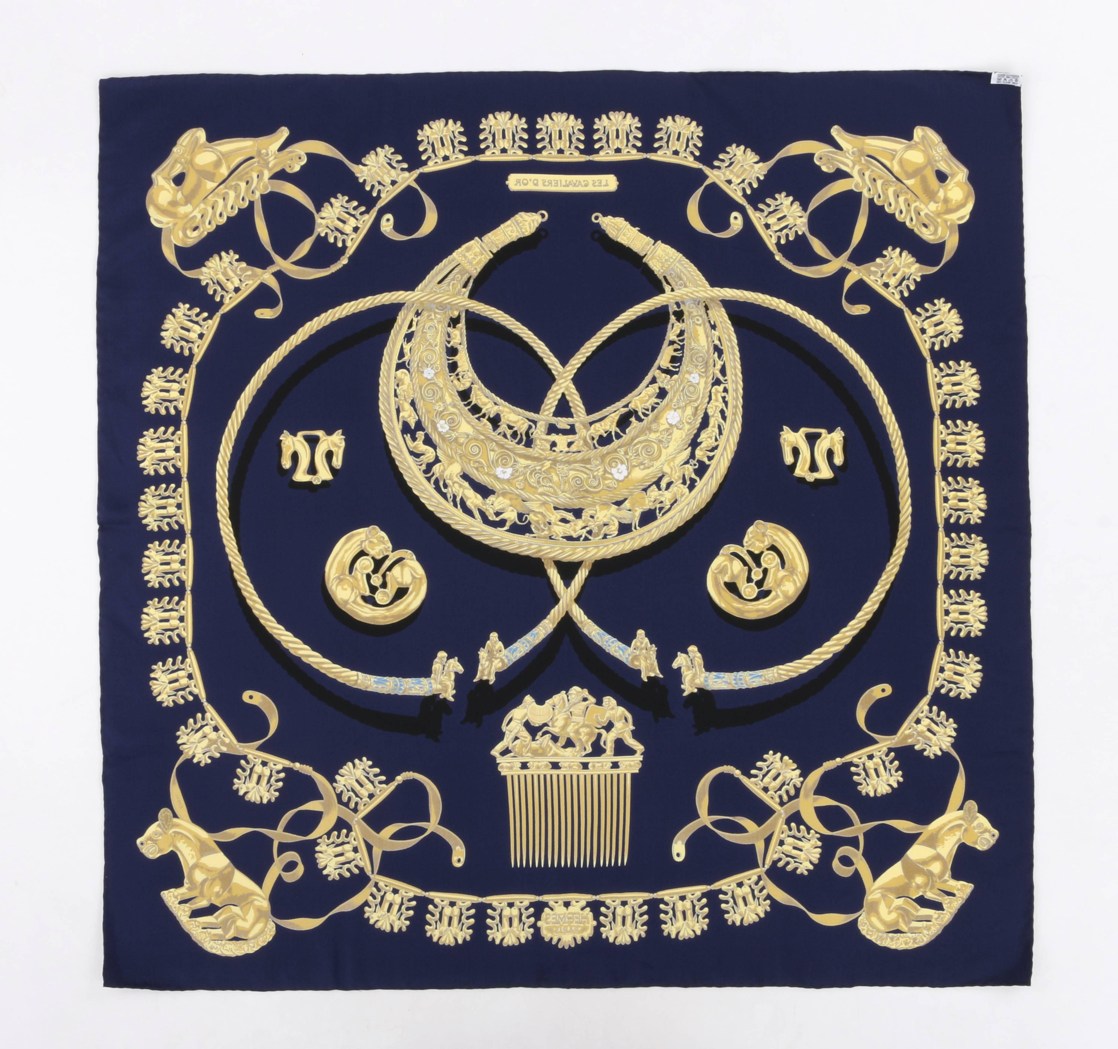Hermes "Les Cavaliers D'or" designed by Vladimir Rybaltchenko (Rybal) silk scarf. Navy background with gold Greek Scythian art jewelry; pectorals, horse combs, necklaces, amulets, and clothing buckles printed throughout. "Les