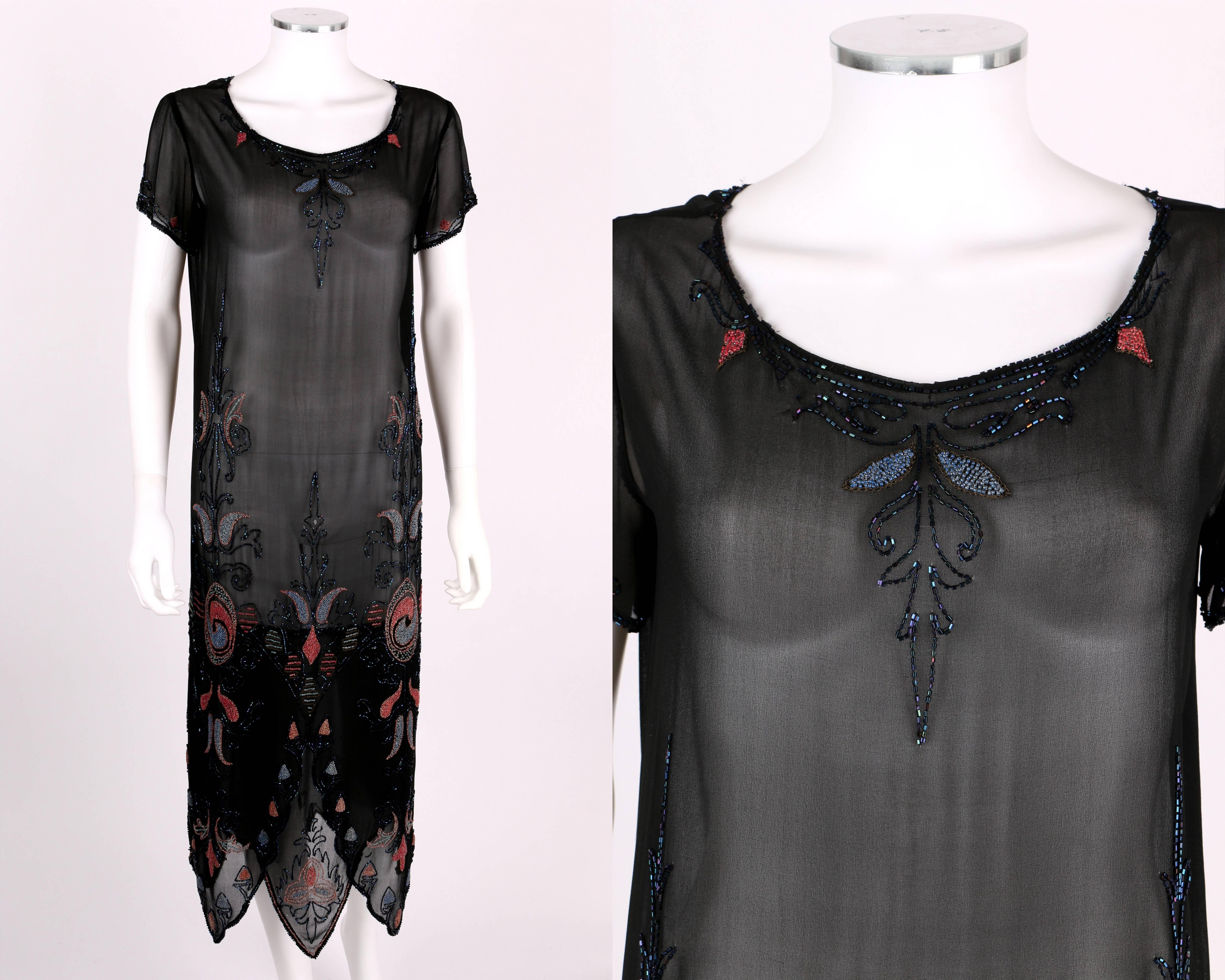 Vintage Couture c.1920's black silk georgette beaded flapper dress. Multicolor floral glass beaded embellishment along front, hemline, neckline, and cuffs. Scoop neckline. Short sleeves. Layered scallop hemline. Two side seam snap closures at waist