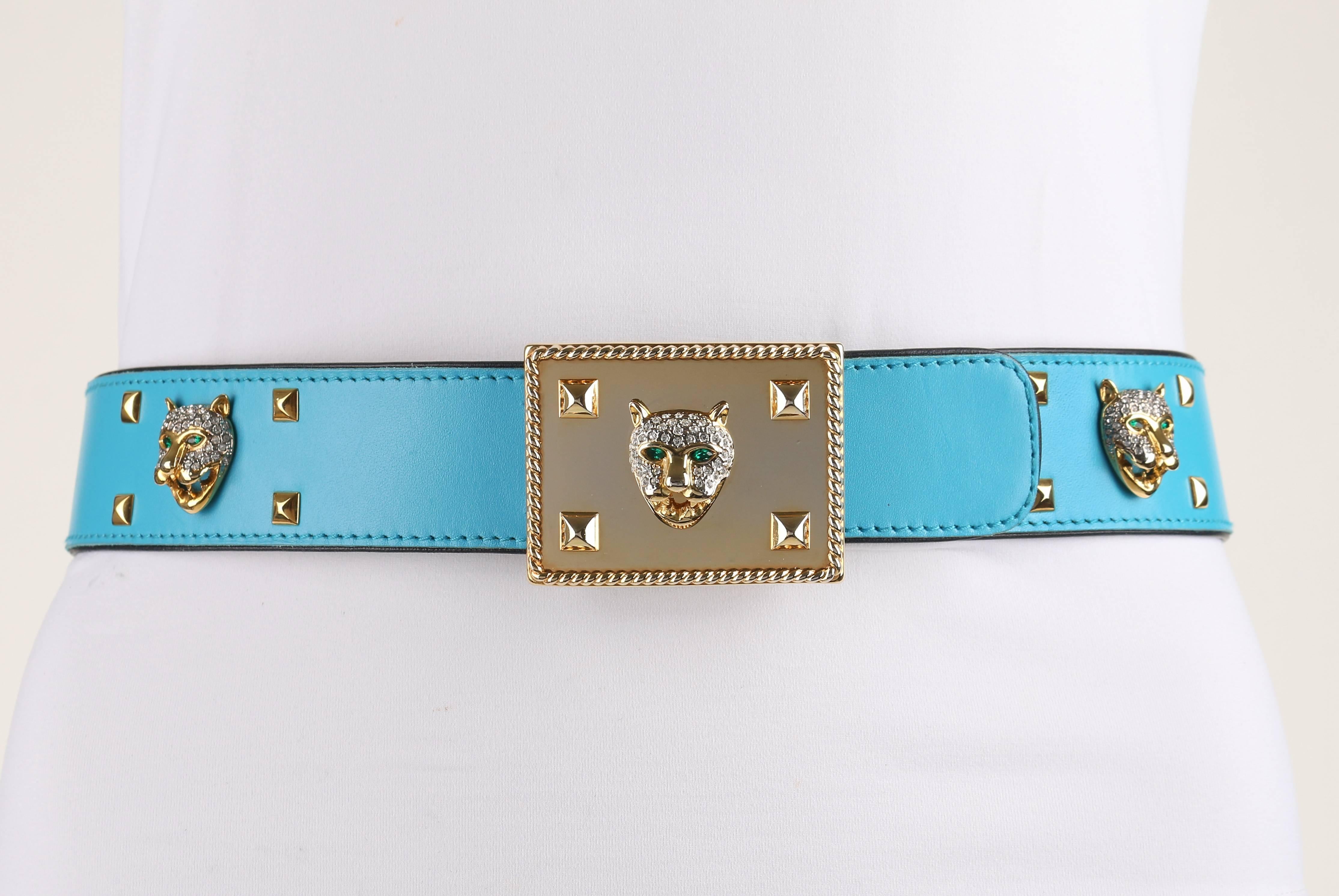 Vintage Escada c.1980's turquoise blue leather rhinestone jaguar studded belt. Turquoise leather body trimmed and backed in black leather. Embellished in gold-toned pyramid studs, jaguar heads with emerald toned eyes and rhinestone spots, and