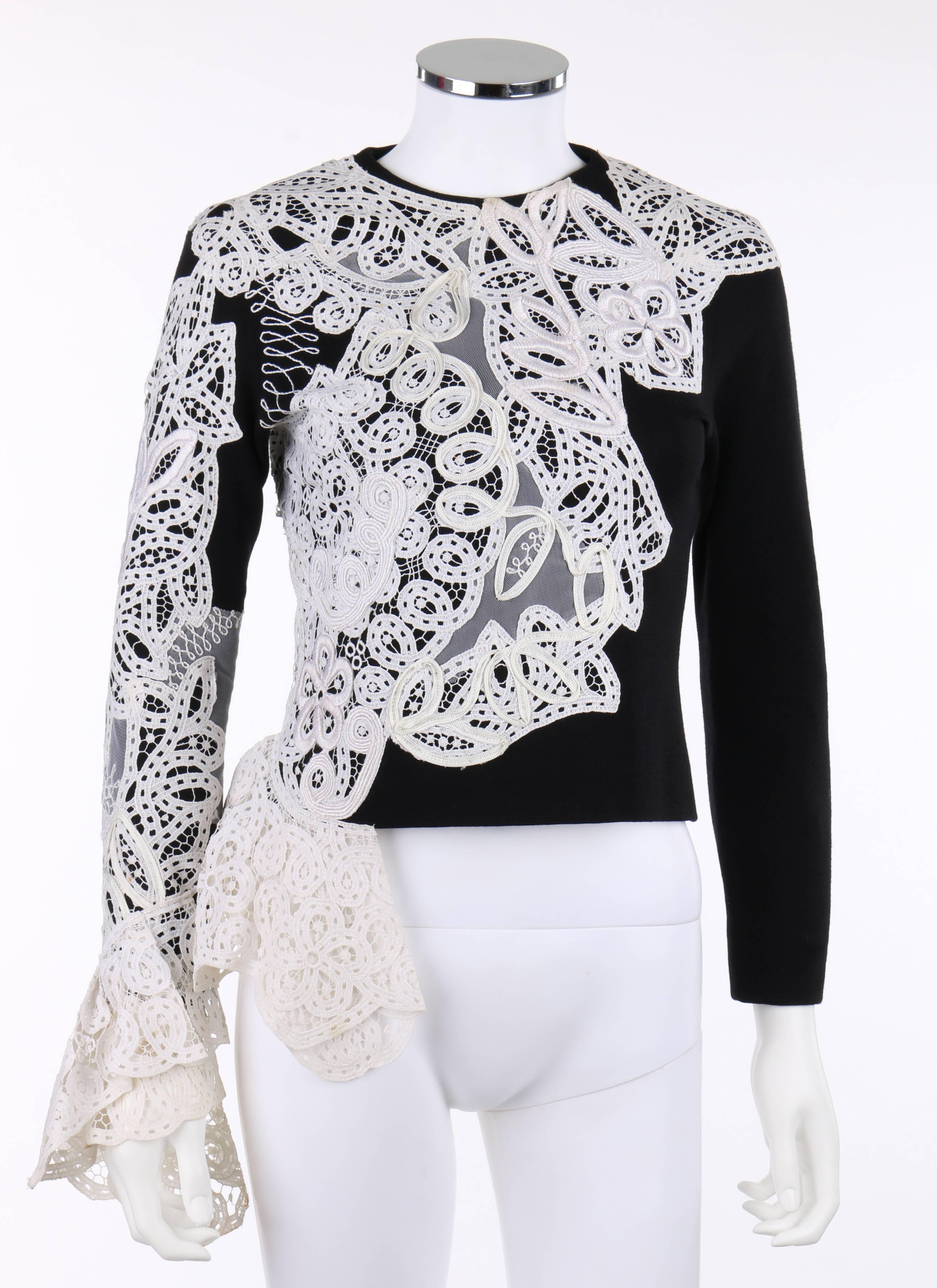 Vintage Gianfranco Ferre A/W 1988 black wool knit white avant garde lace applique top. White floral lace, braid, and tulle asymmetrical applique detail. Flounced lace at right cuff and hemline. Black wool jersey. Crew neckline. Long sleeves with