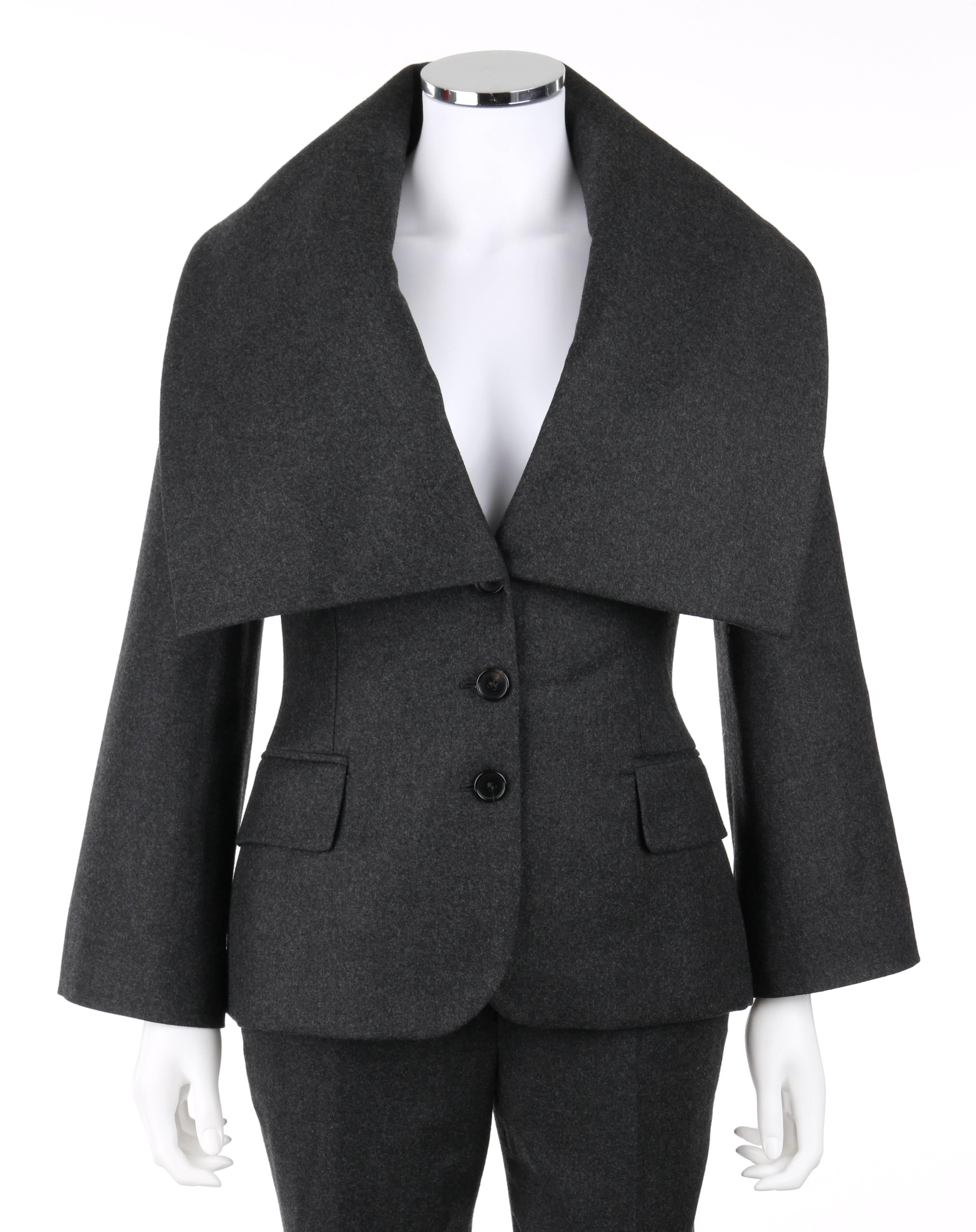 Alexander McQueen Pre-Fall 2009 two piece gray wool cashmere pant suit. Long bell sleeve blazer. Over-sized collar. Three center front button closures. Two front welt flap pockets. Single center back vent. Fully lined. Matching slim fit trousers.