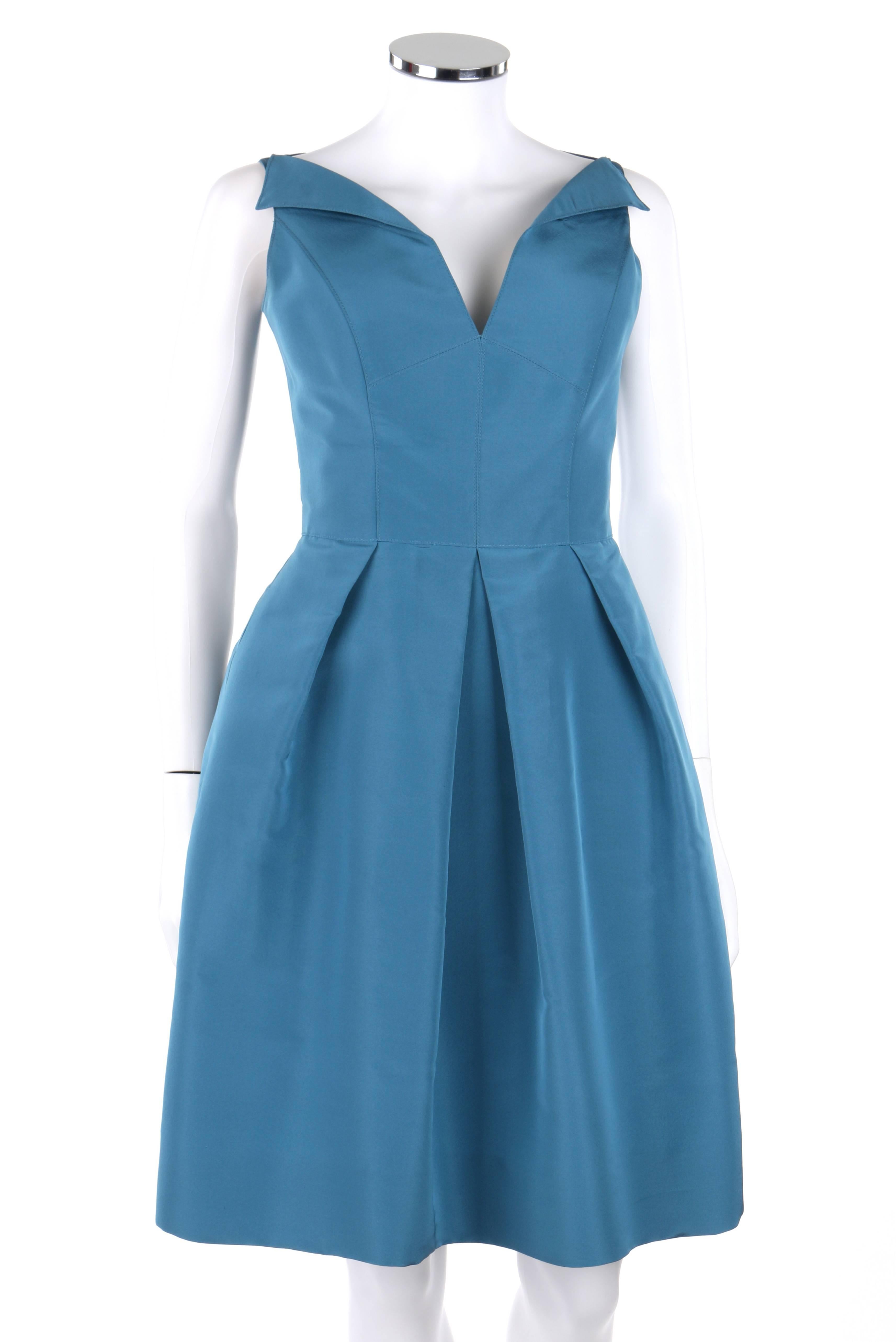 Oscar de la Renta Resort 2008 teal 100% silk sleeveless cocktail dress. Bateau v-neckline with lapels. Princess seams. Knife pleated skirt. Two front inseam pockets. Center back invisible zipper with hook and eye closure at top. Fully lined.