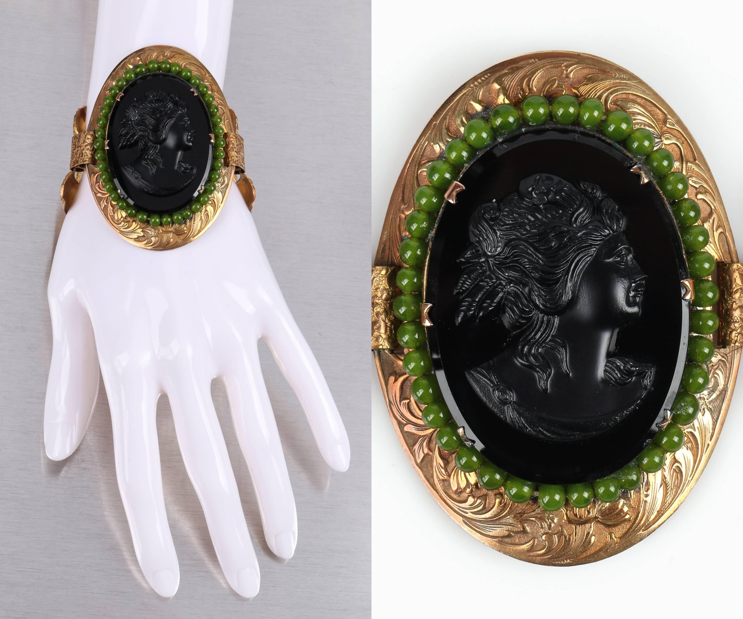 Vintage c.1930's Victorian Revival black glass cameo bronze link statement bracelet. Oval black glass Grecian cameo, surrounded by moss green glass beads. Six prong large oval bronze toned floral engraved setting. Large rectangular open link floral