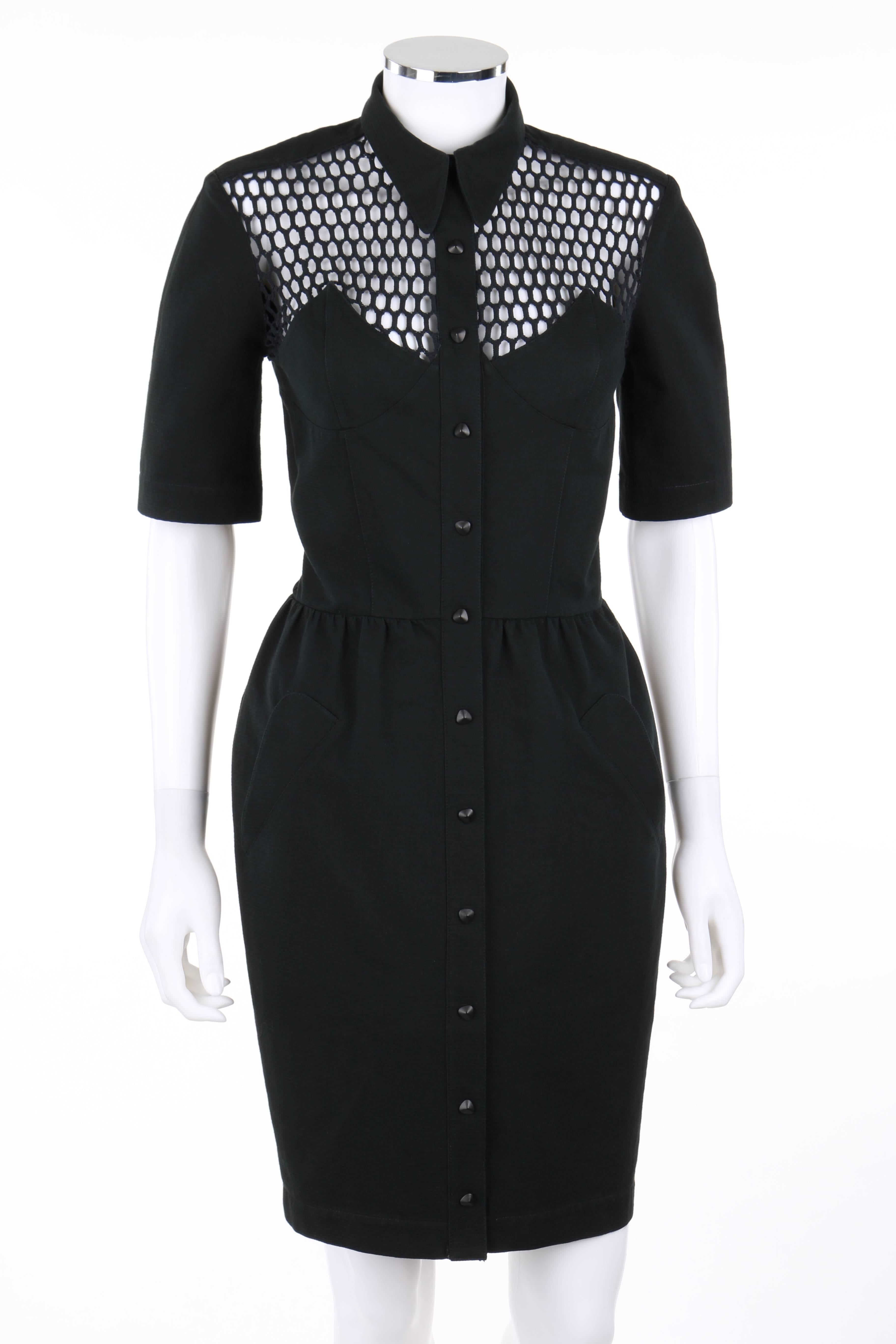 Thierry Mugler S/S 1985 shirt dress. Illusion fish net front and back at top of bodice. Shirt collar. Pointed bust detail. Short sleeves. Twelve center front black triangle shaped snap closures. Sheath style. Two front angled hip pockets. Partially