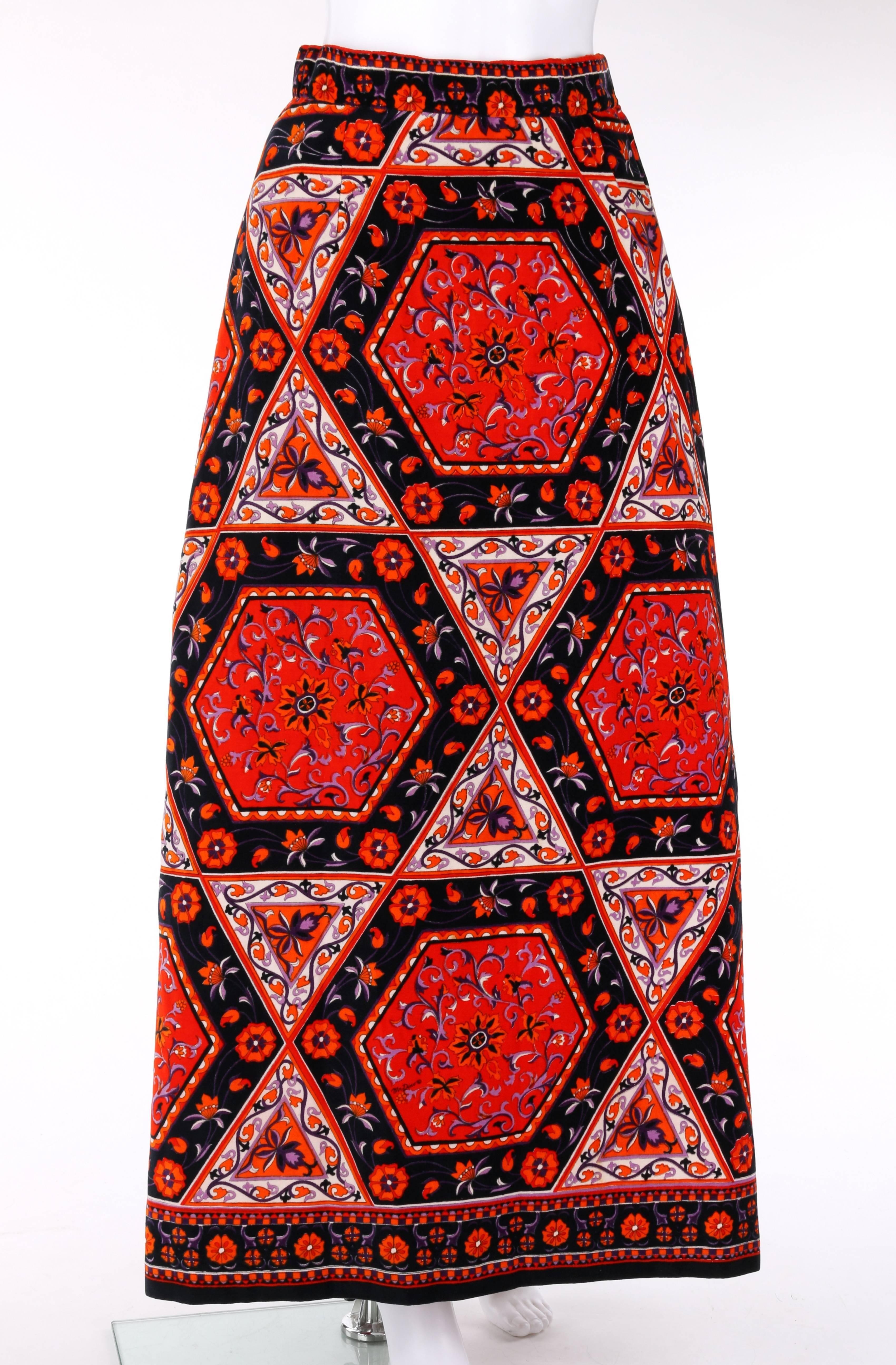 Vintage Mr. Dino c.1970's velvet print maxi skirt. Floral and geometric (hexagon and triangle) print in shades of red, orange, purple, and black. Left side seam slit. Side seam zipper and two hook and loop closures at top. Partially lined. Marked