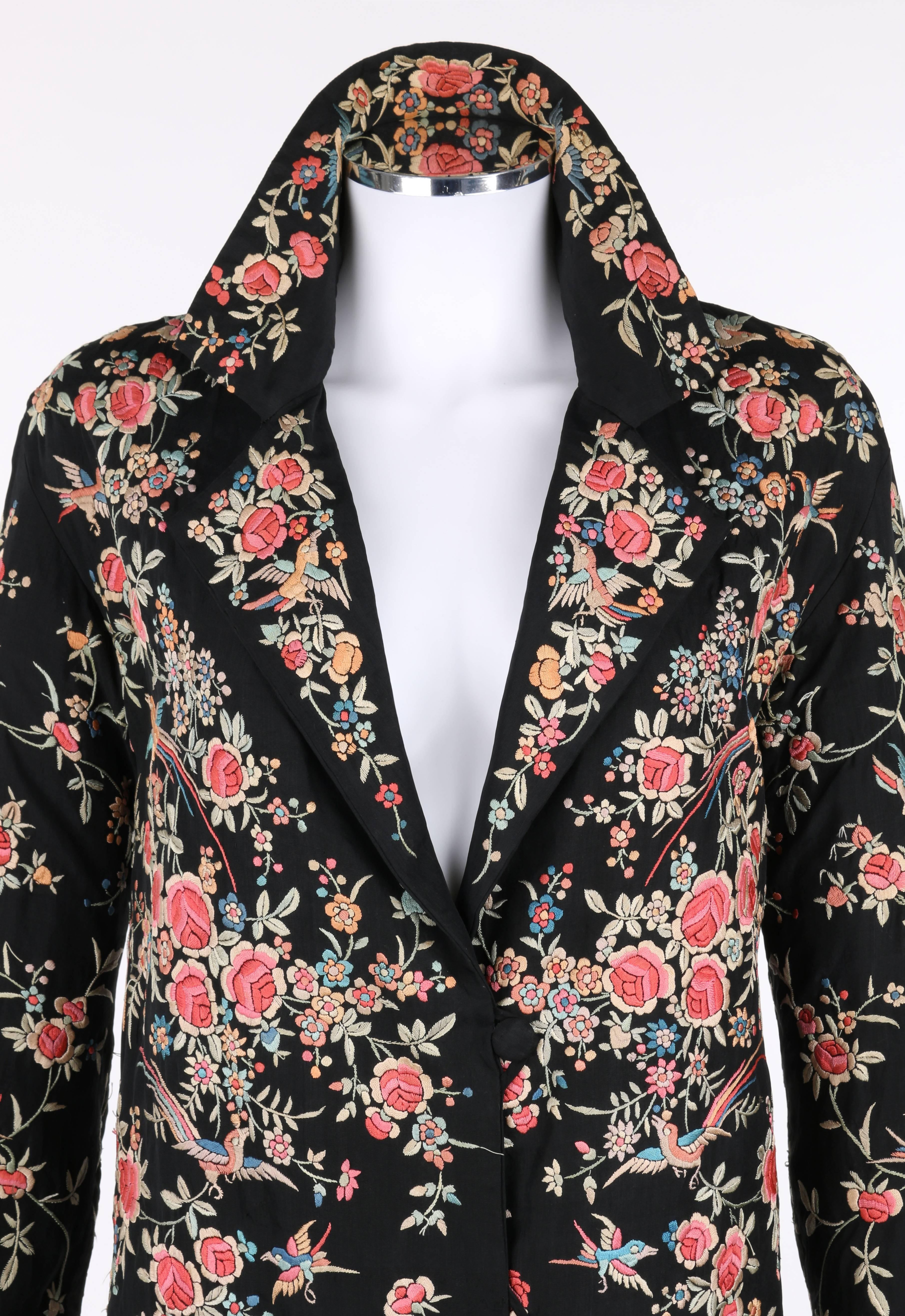 Vintage c.1920's black silk asian embroidered jacket. All over multi-colored silk floral and bird hand embroidery with scalloped boarder at cuffs and hemline. Notched lapel collar. Three center front covered button and loop closures. Long sleeves.