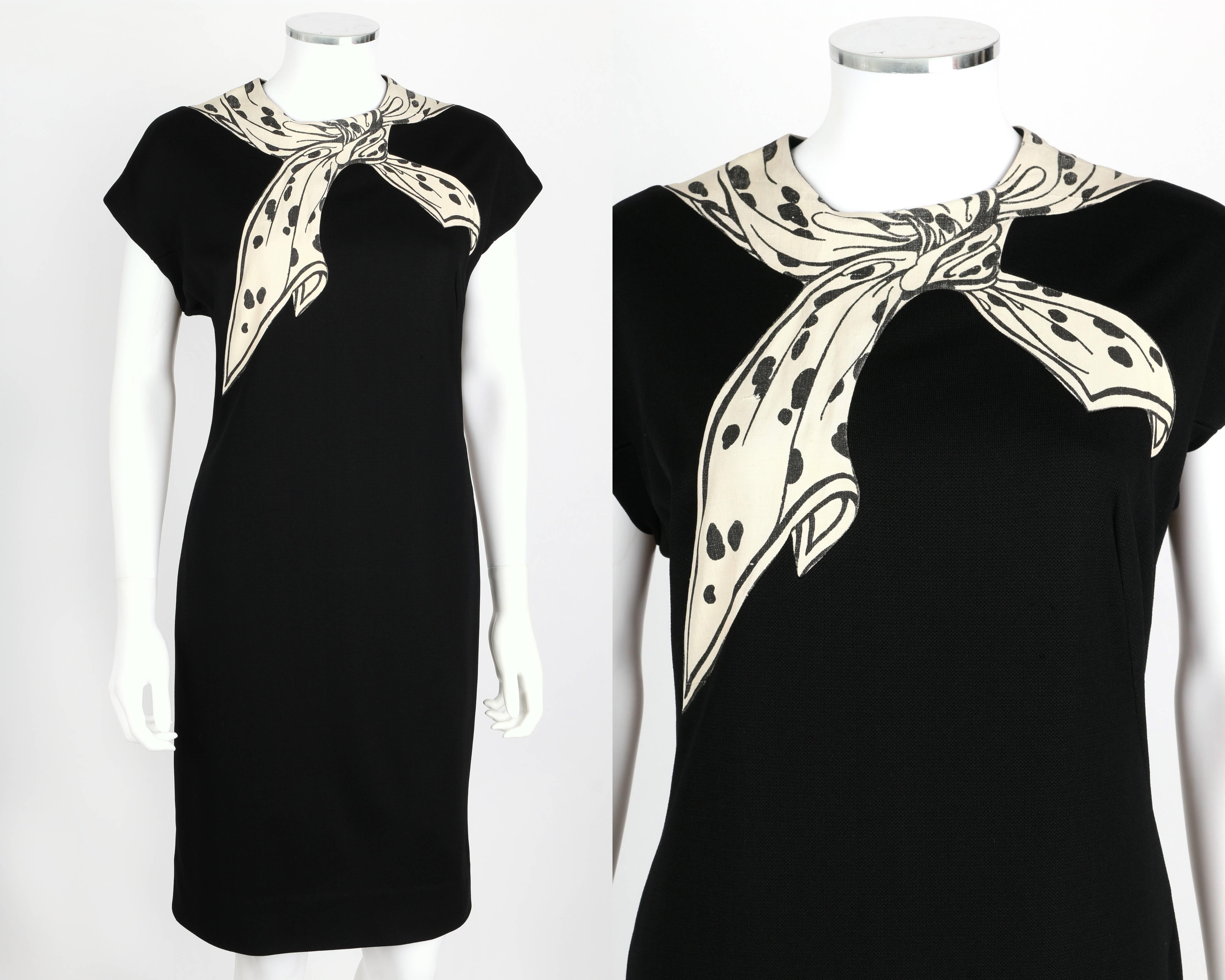 Vintage Sydney North c.1960's black knit shift dress. Ivory and black polka dot trompe l'oeil scarf painted on silk inset around scoop neckline. Extended shoulders. Center back invisible zipper with hook and eye closure at top. Partial lining