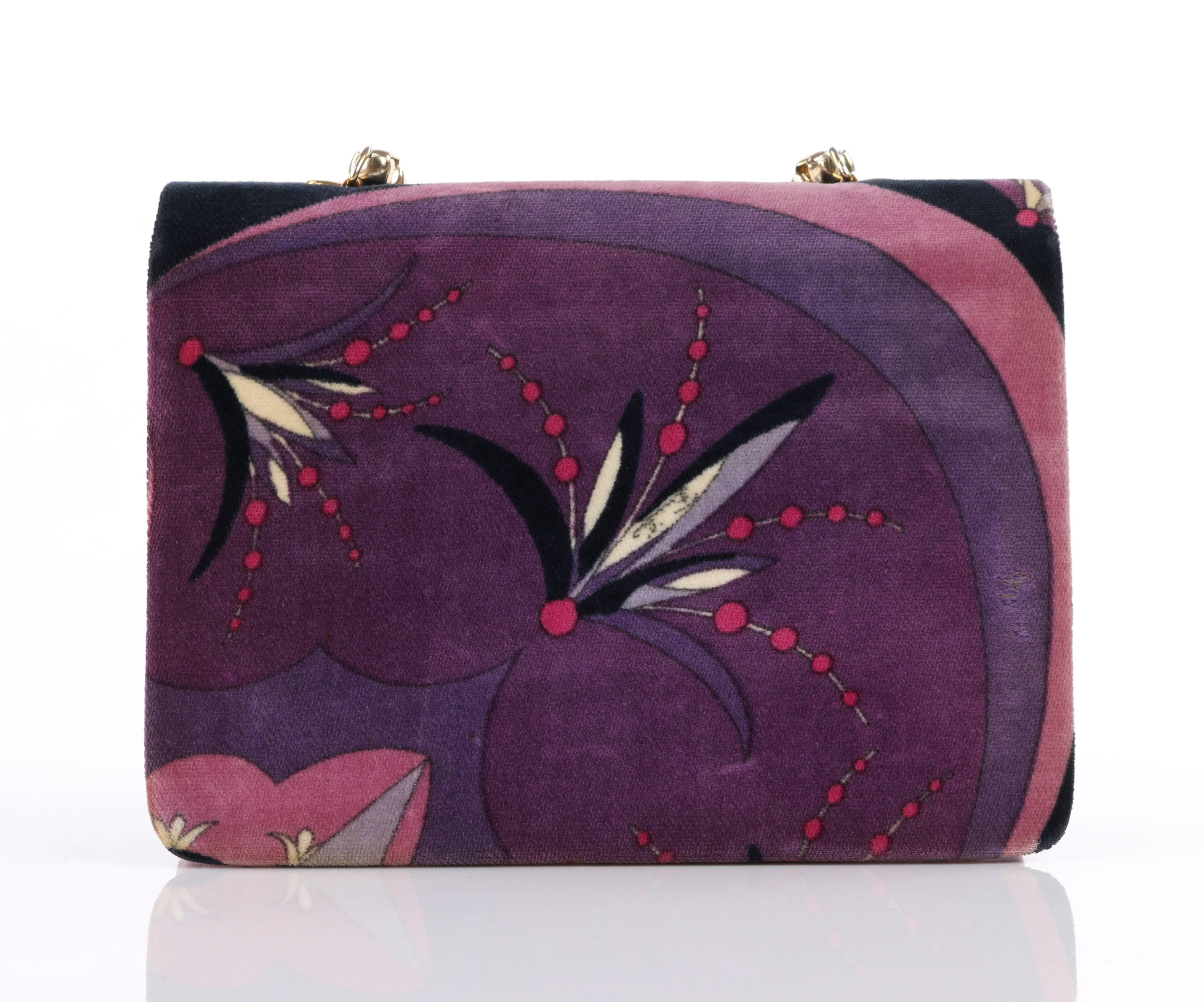 Vintage Emilio Pucci c.1970's multi-color velvet floral scalloped signature print purse in shades of purple, cream, fuchsia, and black. Gold toned box chain handle. Two interior expandable compartments with tiered flap tops and snap closures. Back