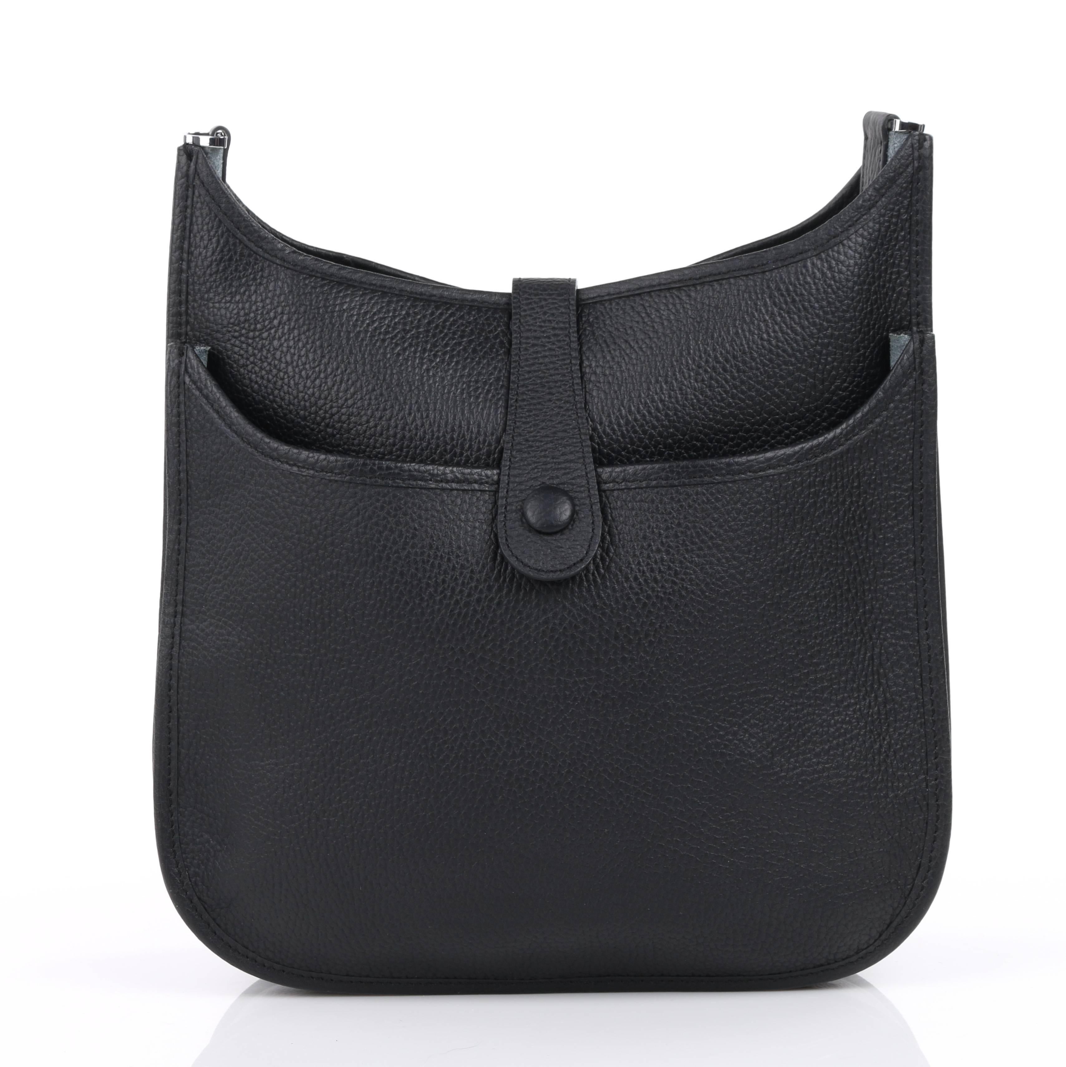 Hermes "Evelyn III 29 PM" black Clemence calfskin leather shoulder bag. Center front perforated "H" oval logo detail. Leather tab with single snap closure at top. Adjustable canvas shoulder strap with silver-toned lobster claw