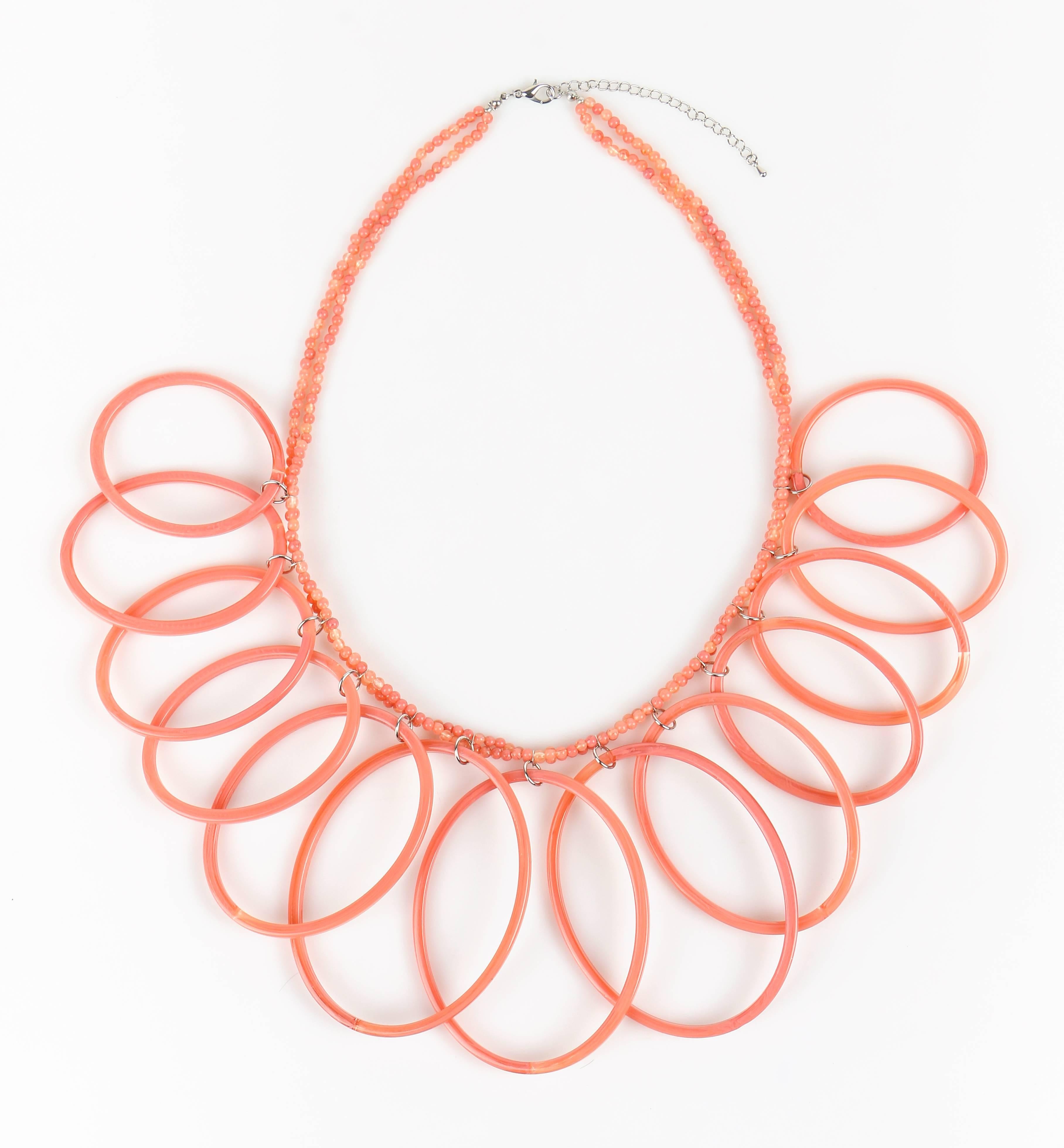 Extremely Rare - Vintage Missoni c.1980's New old stock pink salmon lucite oval hoops statement necklace. Pink salmon semi-translucent marbleized lucite like plastic. Double strand small round seed beads. Large oval hoop pendants in varying sizes