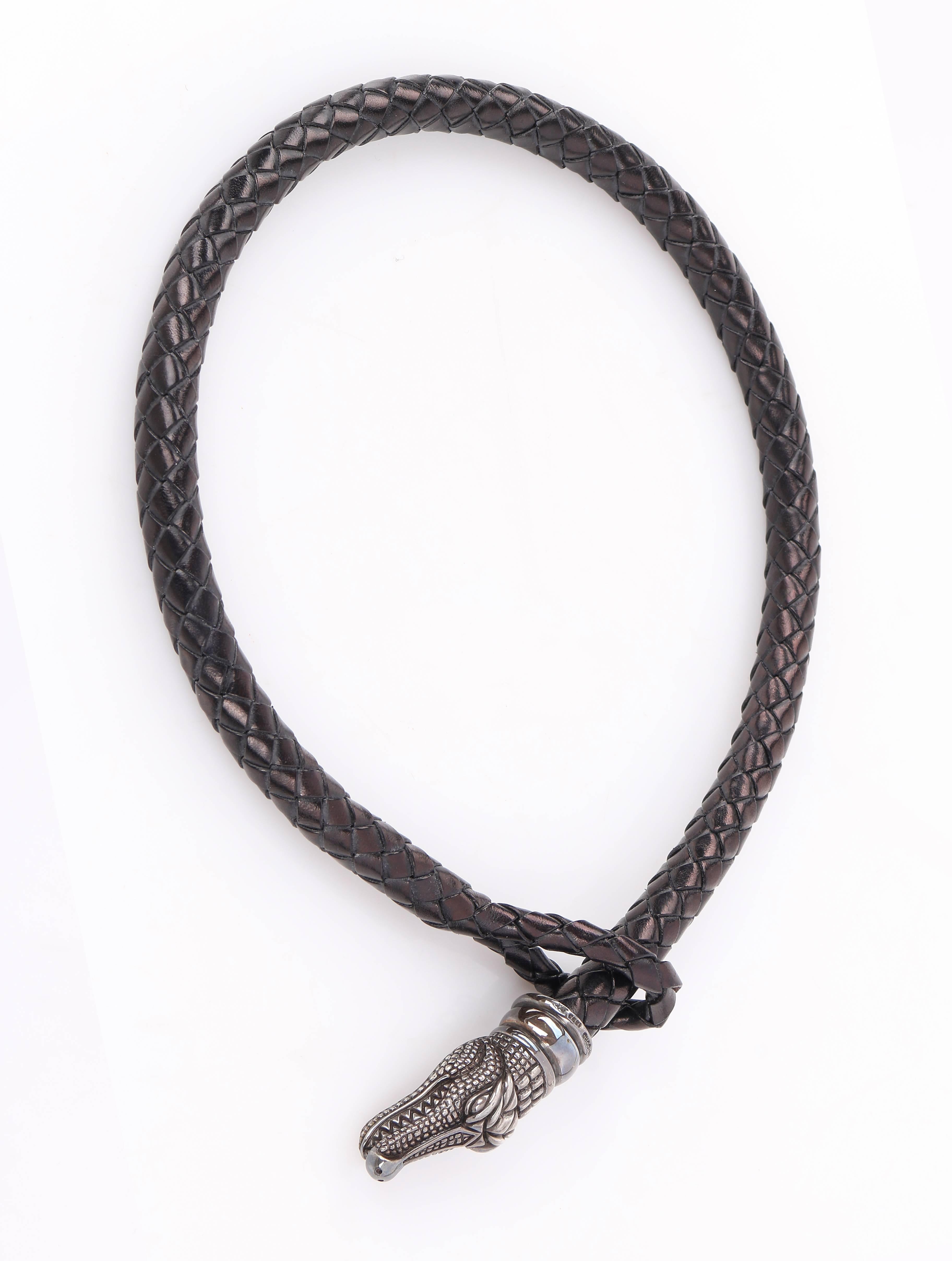 Kieselstein-Cord c.1993 black braided leather cord choker necklace. Braided leather cord has loop closure at one end. Sterling silver alligator head pendant rests at other end of leather cord. Pendant is marked with "Kieselstein-Cord 1993"