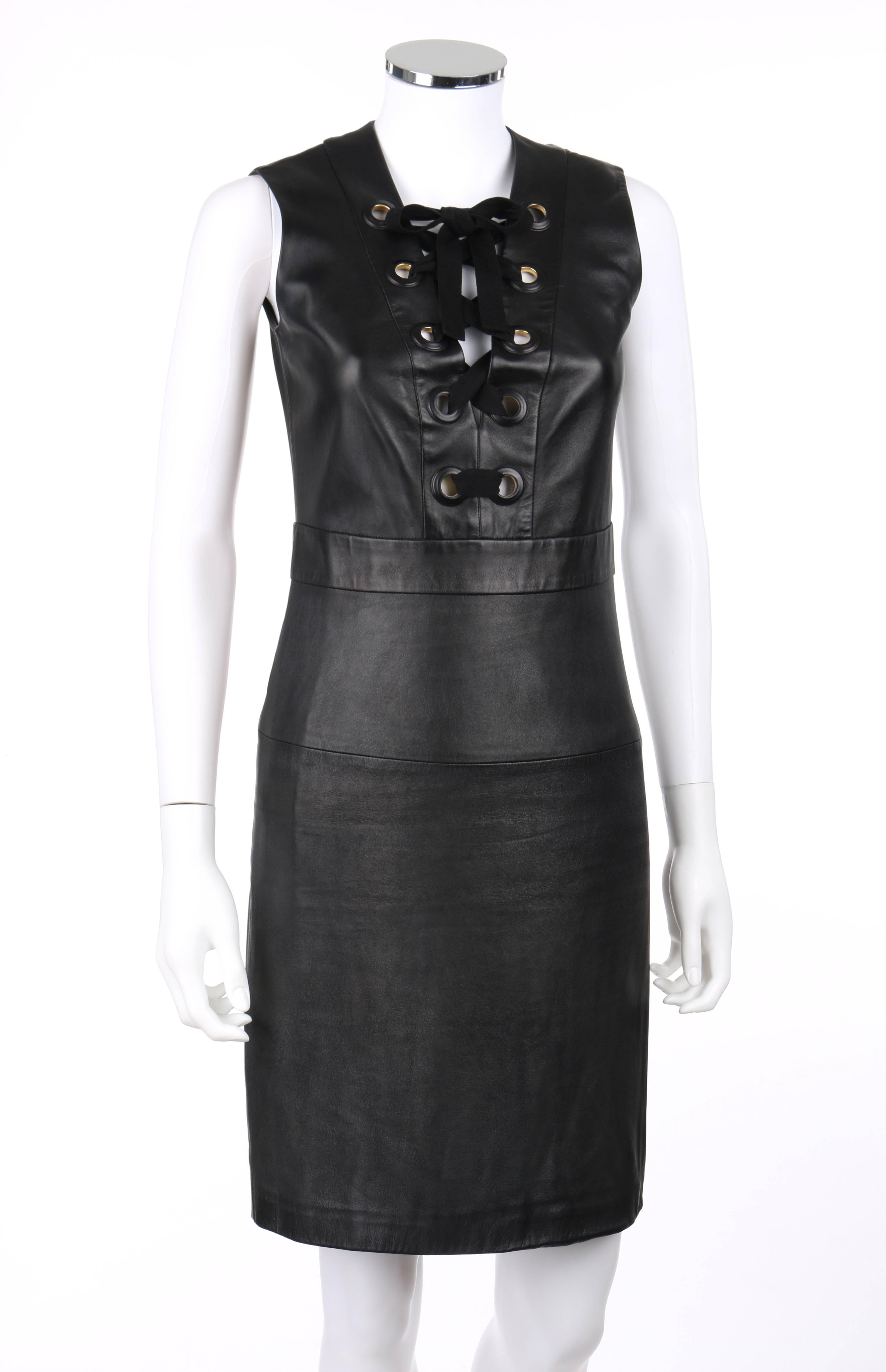 Gucci S/S 2015 black napa leather sheath dress. Deep v-neckline with black cotton twill ribbon and large leather covered grommet lace-up detail. Sleeveless. Banded waistline. Center back invisible zipper with hook and eye closure at top. Fully lined