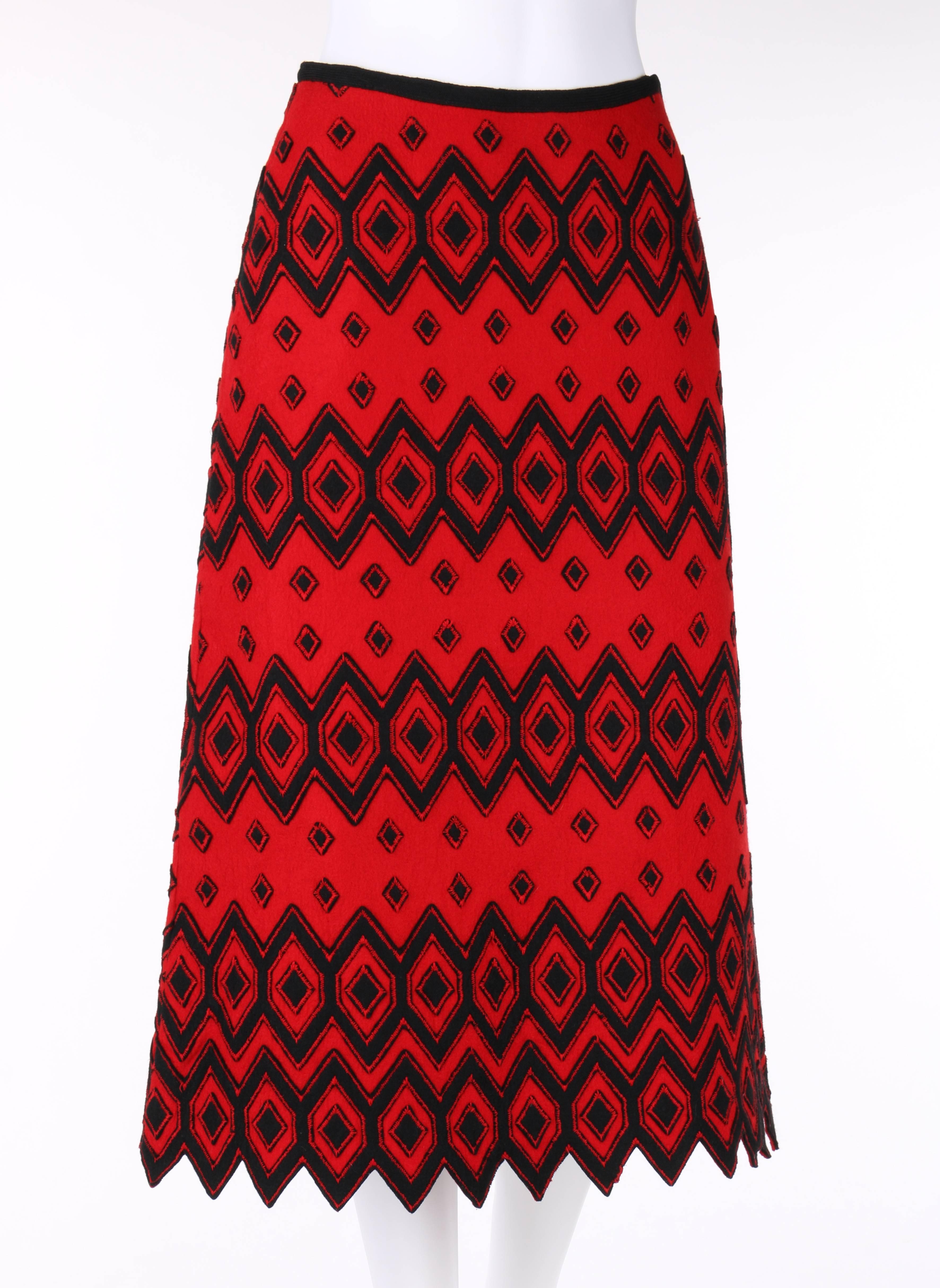 Vintage Anne Klein c.1970's (designed by Donna Karan) red & black wool felt a-line skirt. Black diamond pattern applique with red zigzag stitch detail. Shark tooth hemline. Left side seam zipper with hook and eye at top. Fully lined. Unmarked Fabric
