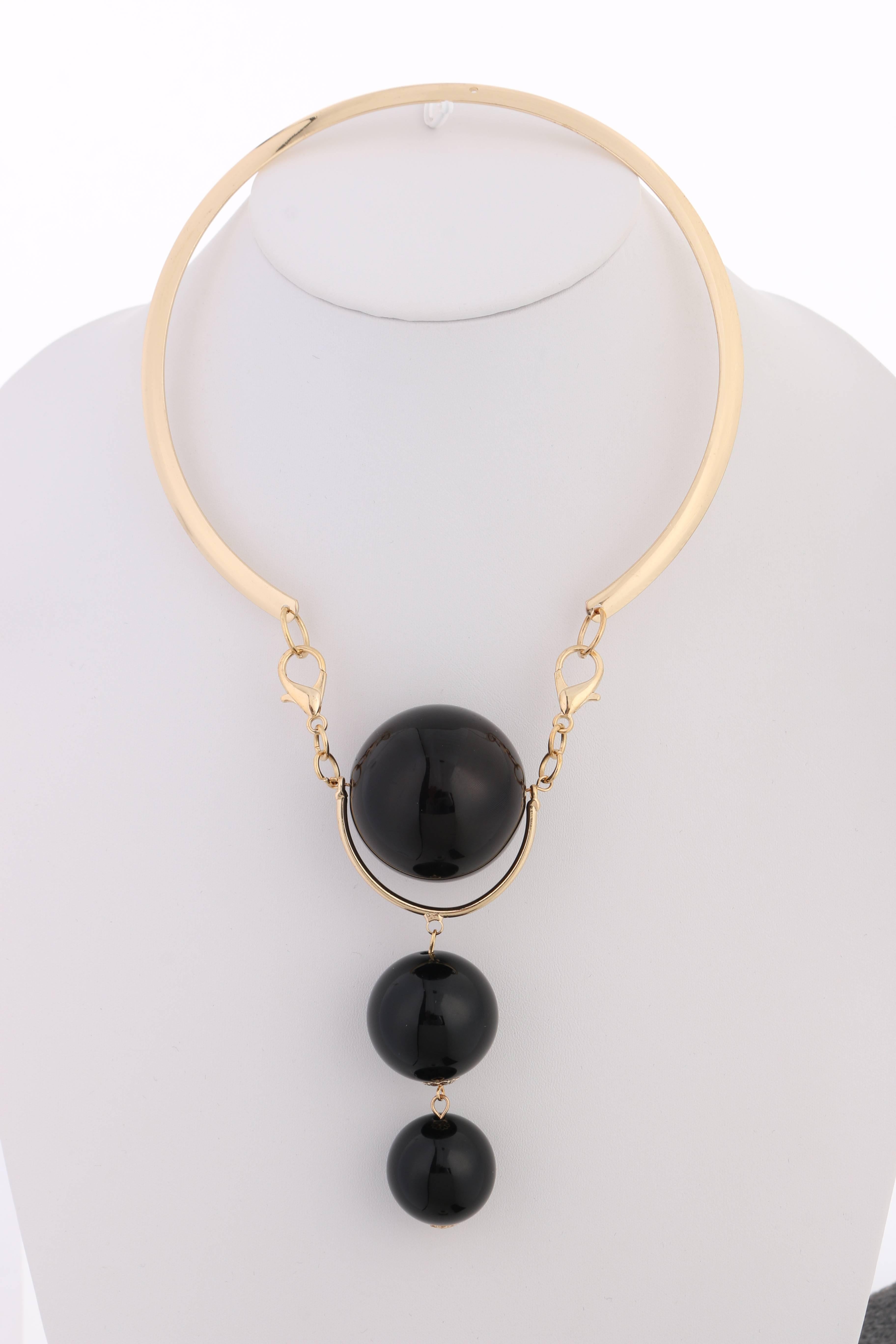 Vintage Versace c.1980's new old stock gold & black modernist sphere pendant choker designed by Ugo Correani. Large modernist pendant made up of three black glossy plastic spheres in varying sizes (38mm - 25mm). Bottom two spheres hang from a thin