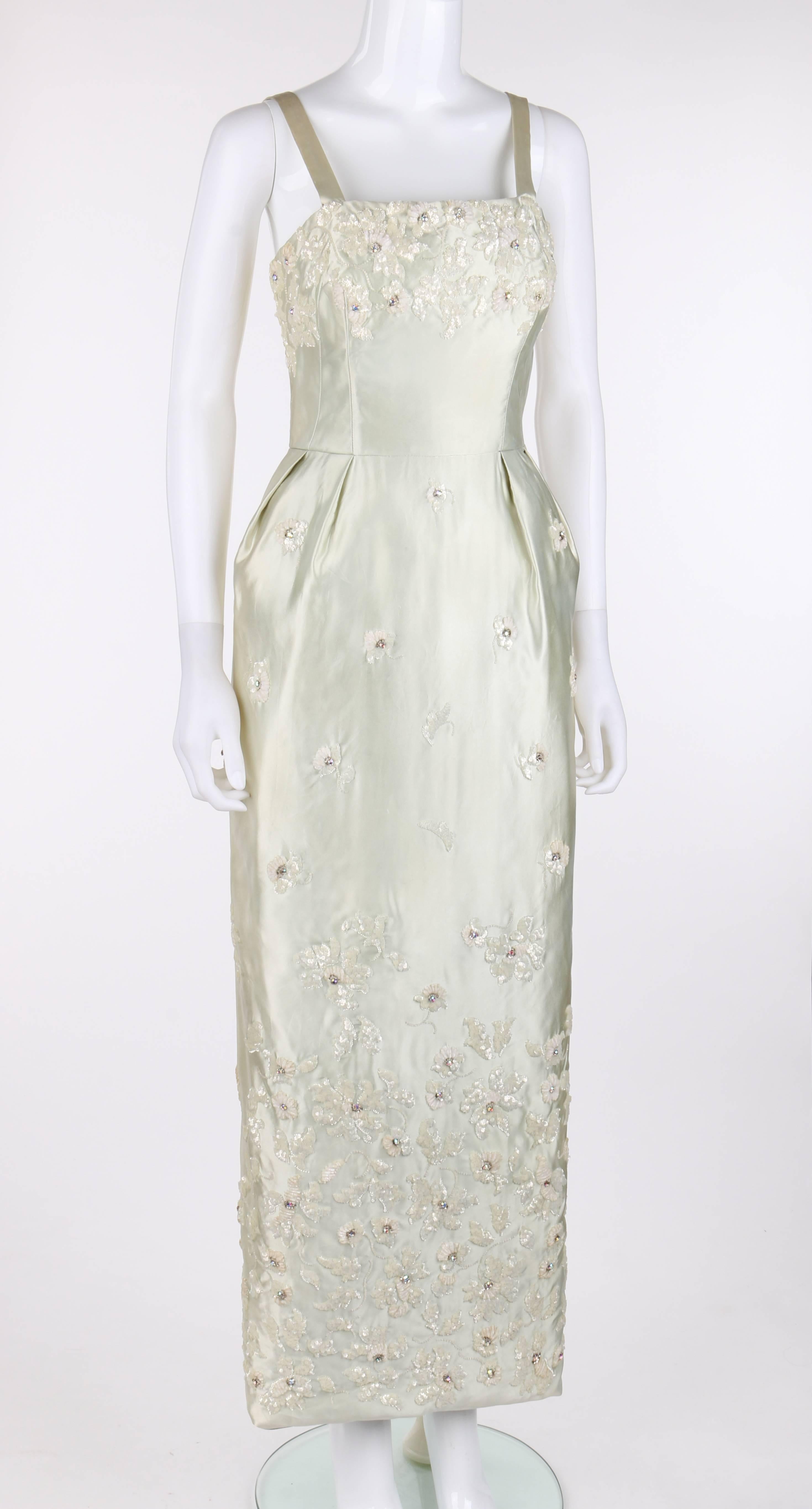 Vintage Givenchy c.1960's Haute Couture numbered pale green silk/satin evening gown. Winter white floral embellishments at top of bodice and descended along skirt to bottom of hem created from thin velvet yarn, floral shaped sequins, tiny seed