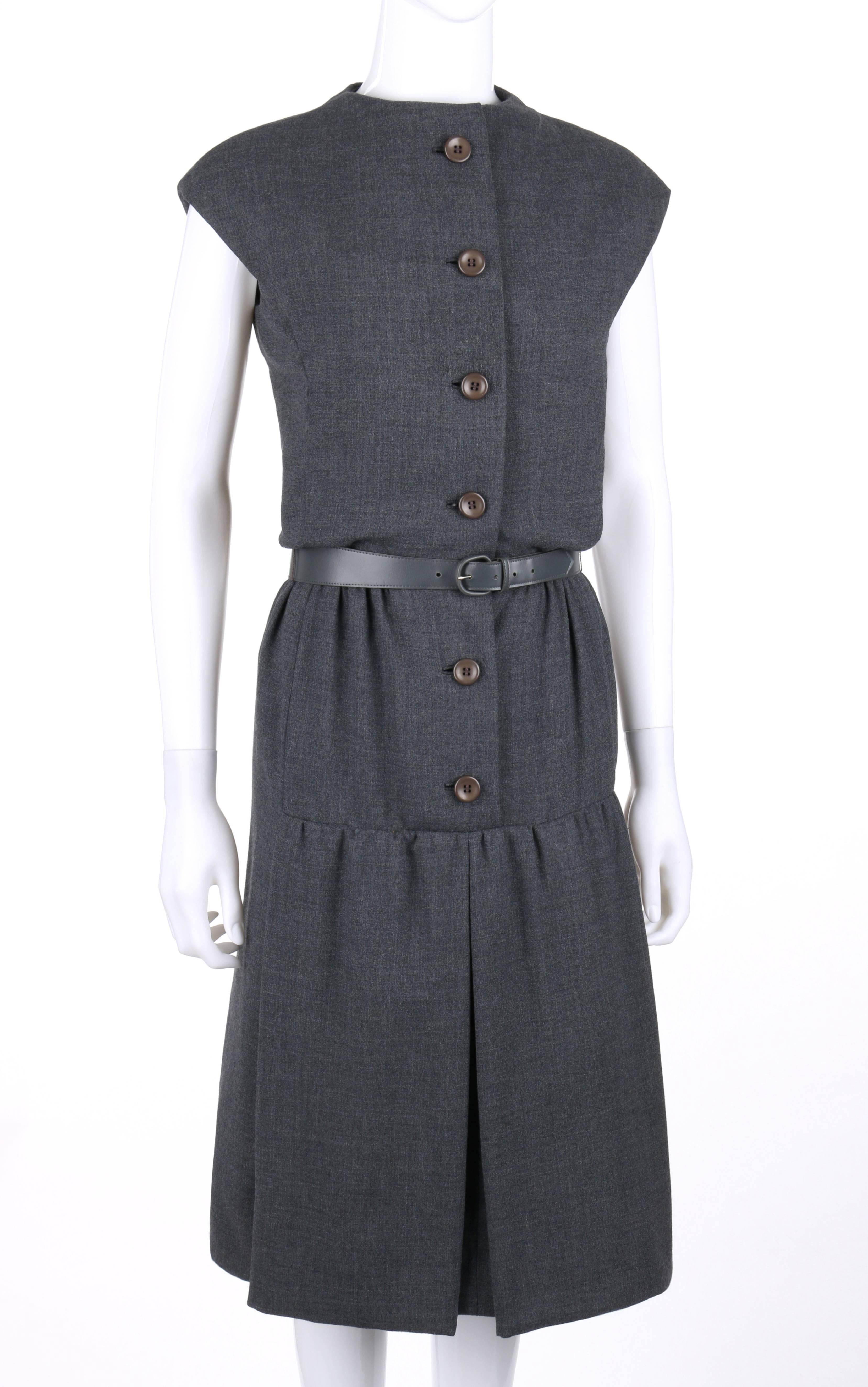 Vintage Geoffrey Beene c.1960's gray wool belted shift dress. Extended shoulders. Built up neckline. Six center front button closures with snap at neckline and hook and eye at waist. Gathered waistline. Two thread chain belt loops. Two gathered box