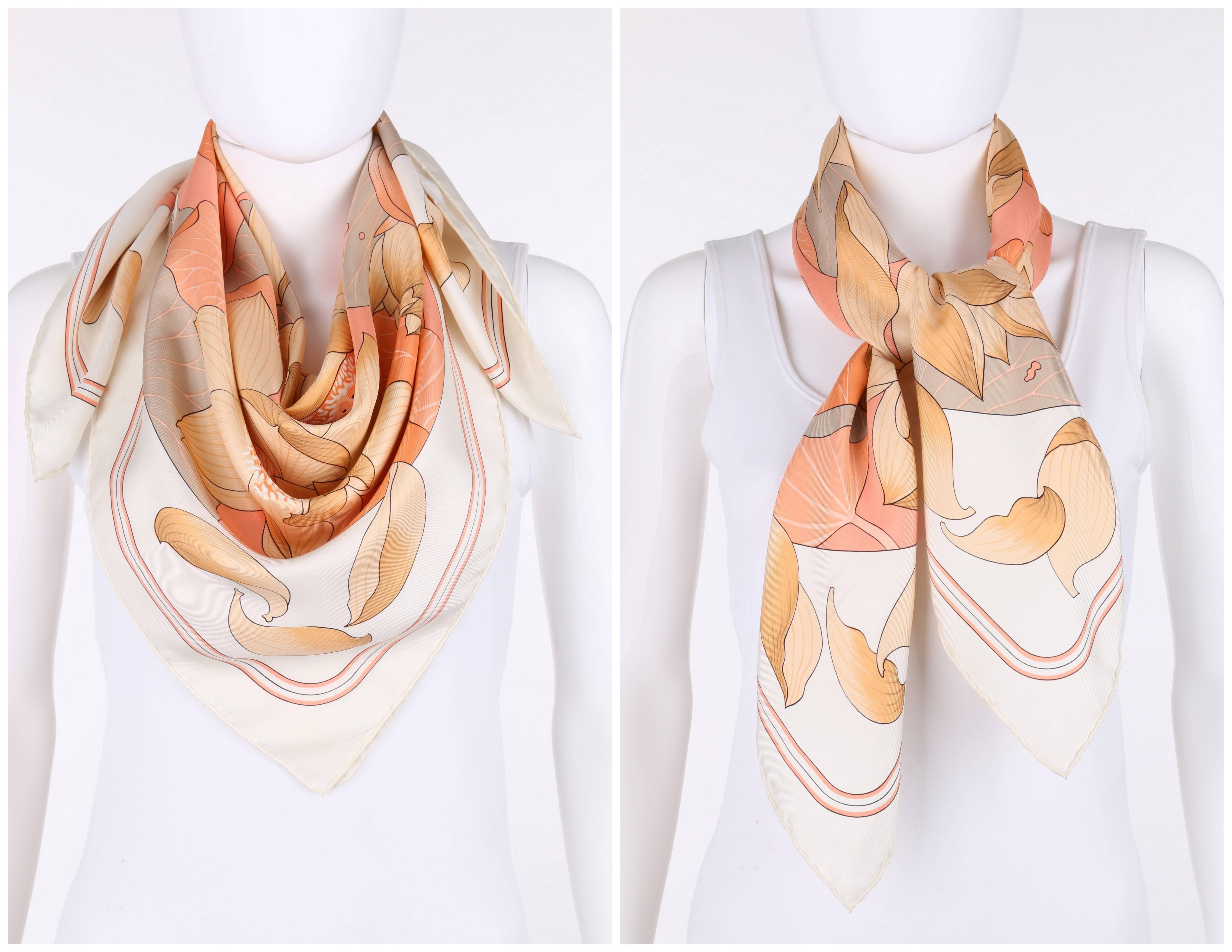 Vintage Hermes c.1976 "Fleurs De Lotus" silk scarf designed by Christiane Vauzelles. Winter white background with thin peach and black rounded line boarder print. Centered gray circular background with tan, beige, and peach lotus flower