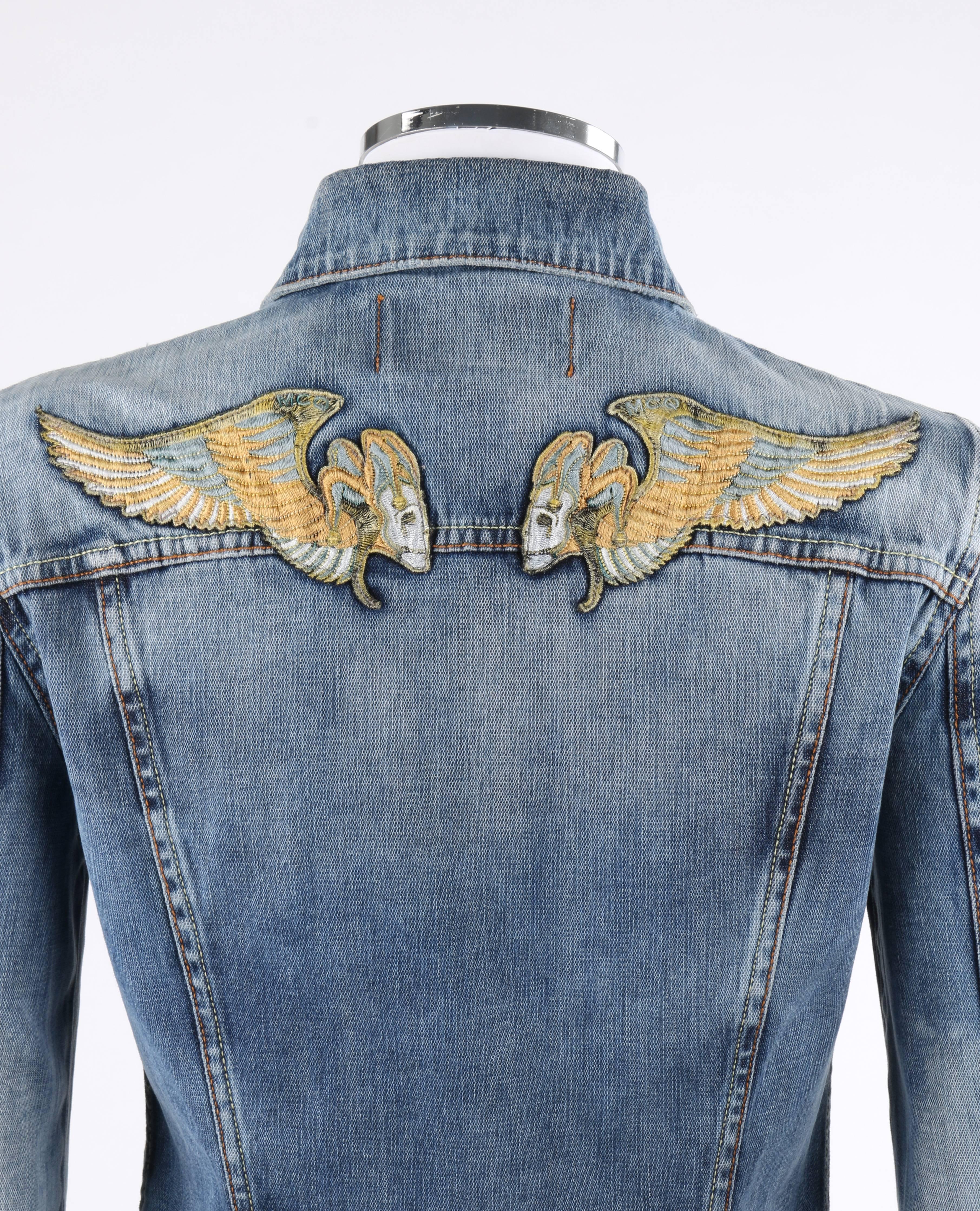 McQ by Alexander McQueen Pre-2010 cotton stone wash denim blue jean jacket with winged jester skull patches at top of back. McQ adaptation of the Angels and Demons recalled line. Bal collar. Pointed front yoke. 3/4 length sleeves with single button
