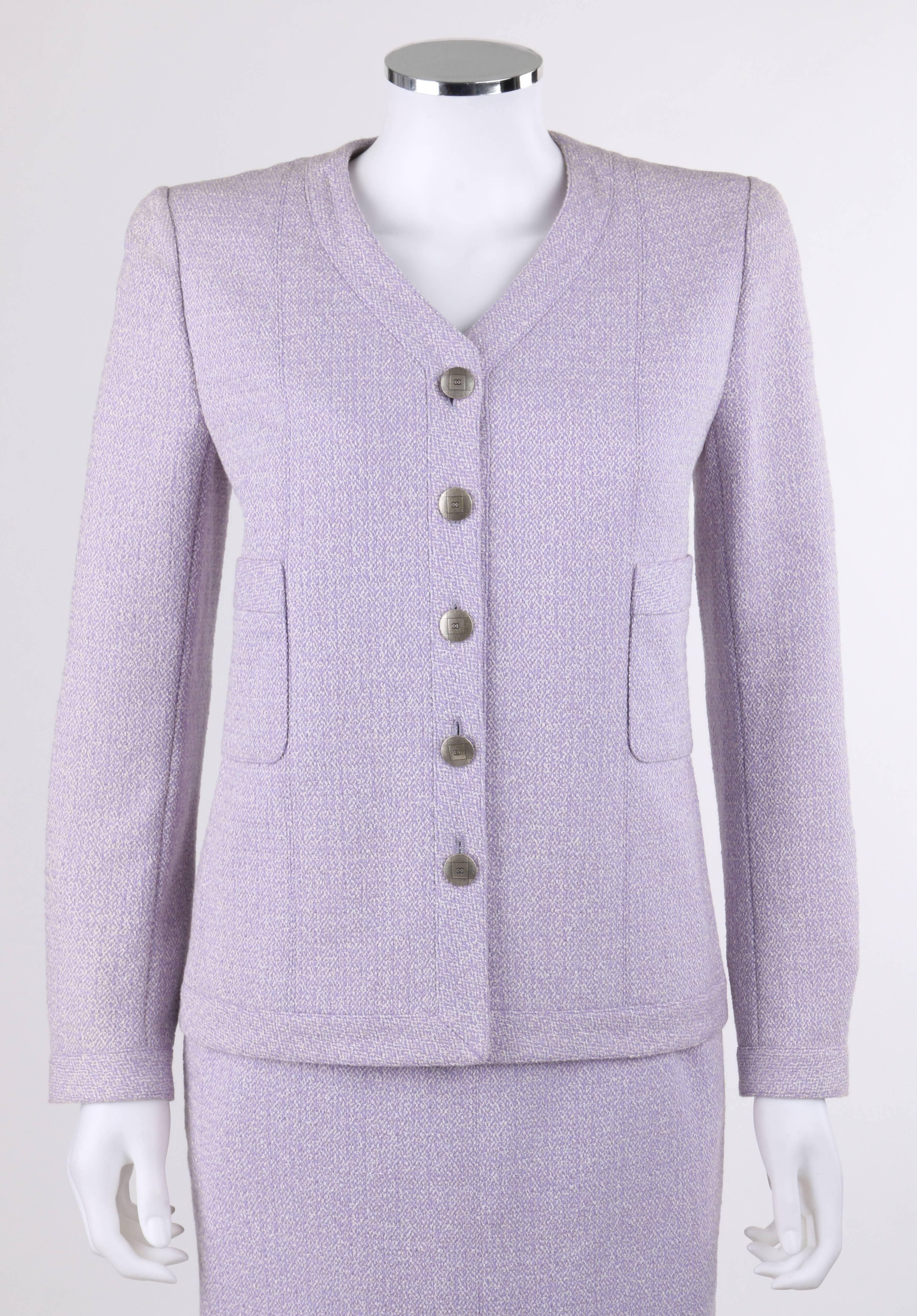 Classic Chanel Spring/Summer 1998 two piece lilac and white wool tweed skirt suit set. Designed by Karl Kagerfeld. V-neckline blazer. Long sleeves with three button closures at cuff. Five center front button closures. Silver-toned round 