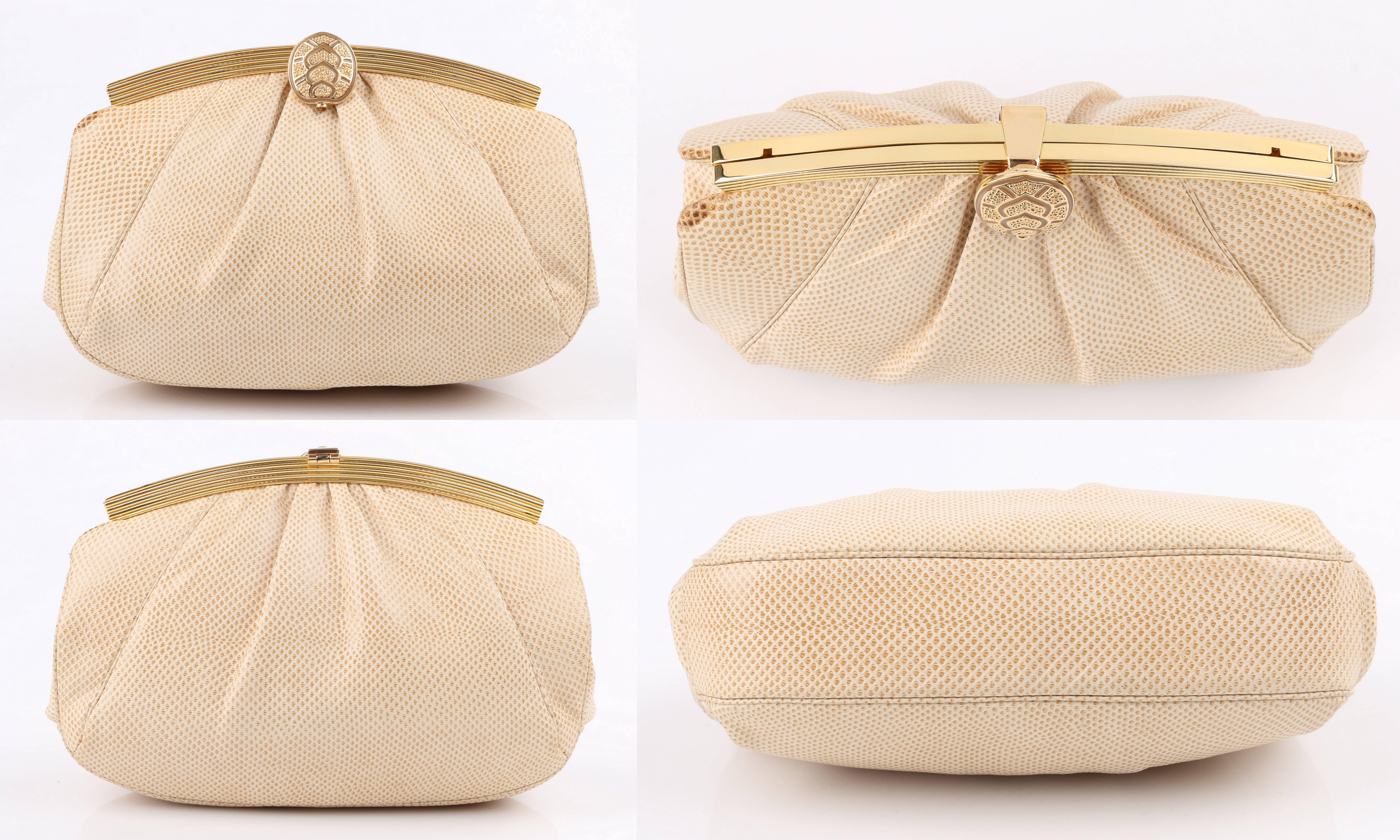 Vintage Judith Leiber c.1980's cream snakeskin leather evening bag. Cream snakeskin exterior gathered into frame at top. Gold-toned metal arched frame with hinged latch closure. Thin gold-toned snake chain cross body strap. Fully lined. Single