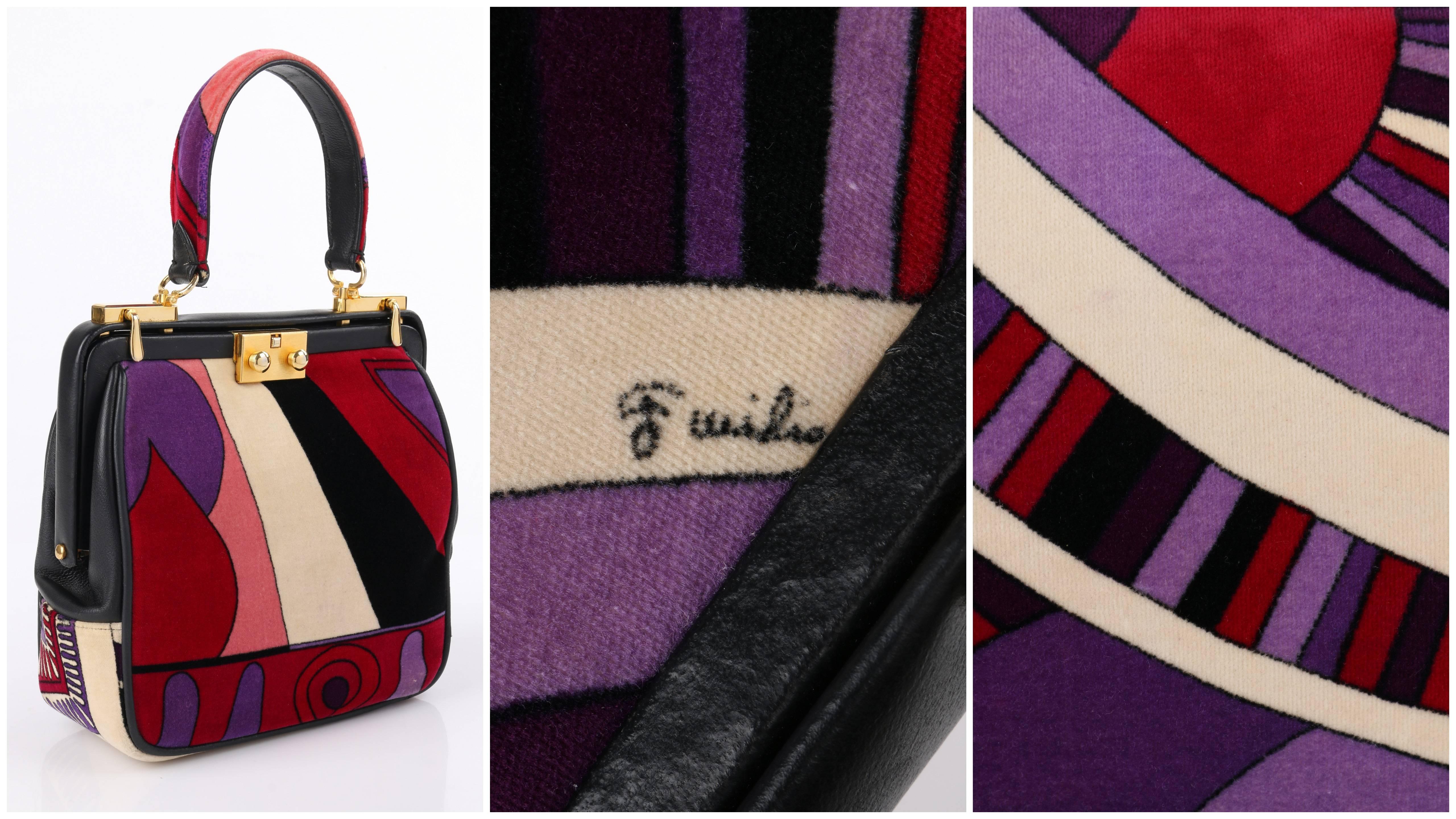 Vintage Emilio Pucci c.1964 "Taitù" signature print cotton velvet and black leather purse. Multicolor op art velvet print in shades of purple, wine red, light pink, black, and ivory with black leather piping. Single top handle with velvet