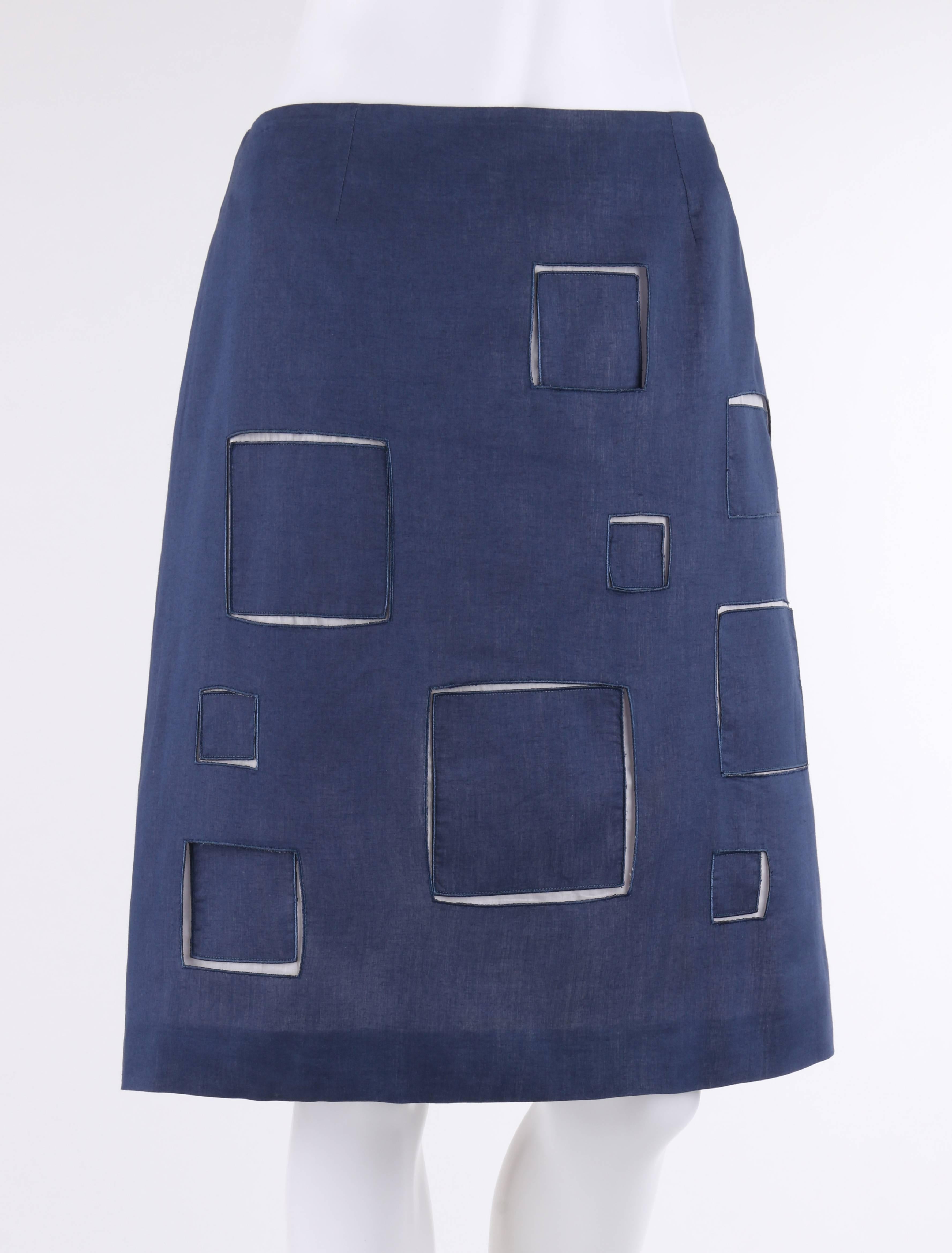 Givenchy Couture Autumn/Winter 1998 blue cotton square cut work skirt designed by Alexander McQueen. Blue cotton overlay with varying sized cut out squares. White cotton under layer with square appliques. Side seam invisible zipper with hook and eye