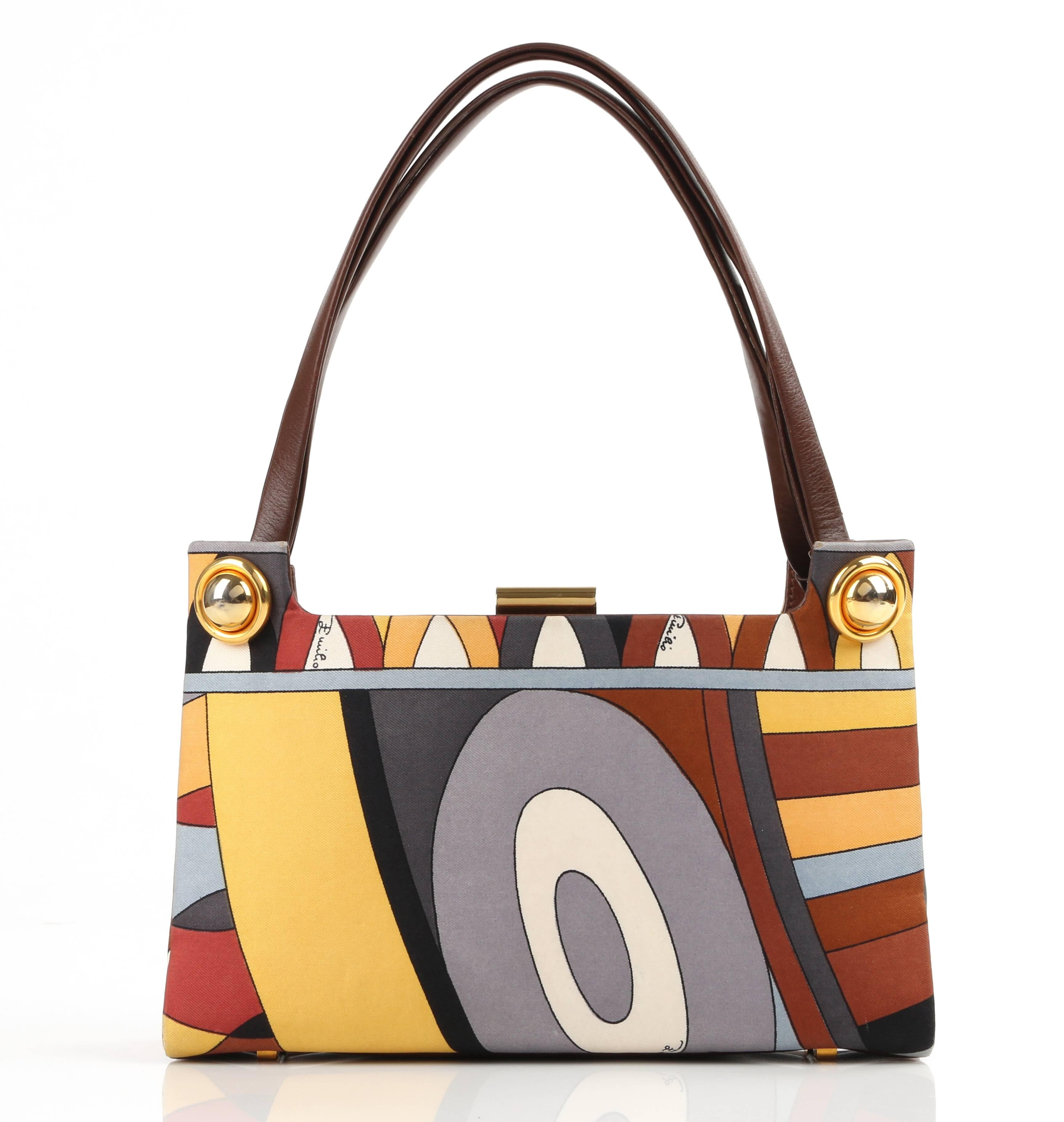 Vintage Emilio Pucci c.1970's brown multi-color signature print silk and leather purse. Multi-color op art signature print silk body in shades of brown, gold, rust red, gray, black, and white. Two flat fold double leather handles. Gusseted sides.