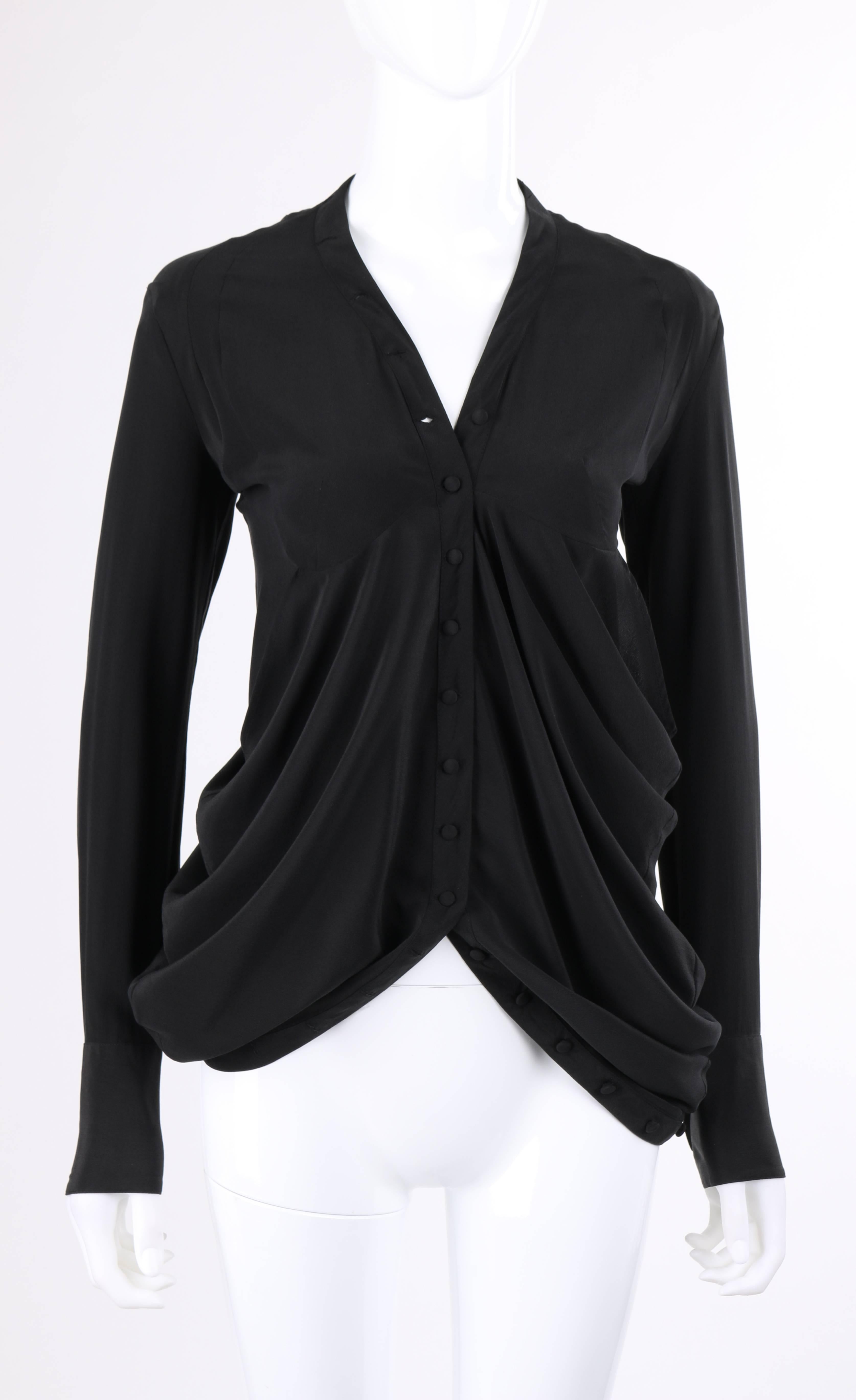 Balenciaga Autumn/Winter 2009 black silk blend asymmetrical draped blouse. Long sleeves with two button closures at cuff. V-neckline. Twenty three center front covered button closures. Stylized rounded under bust seam. Two bias cut asymmetrical