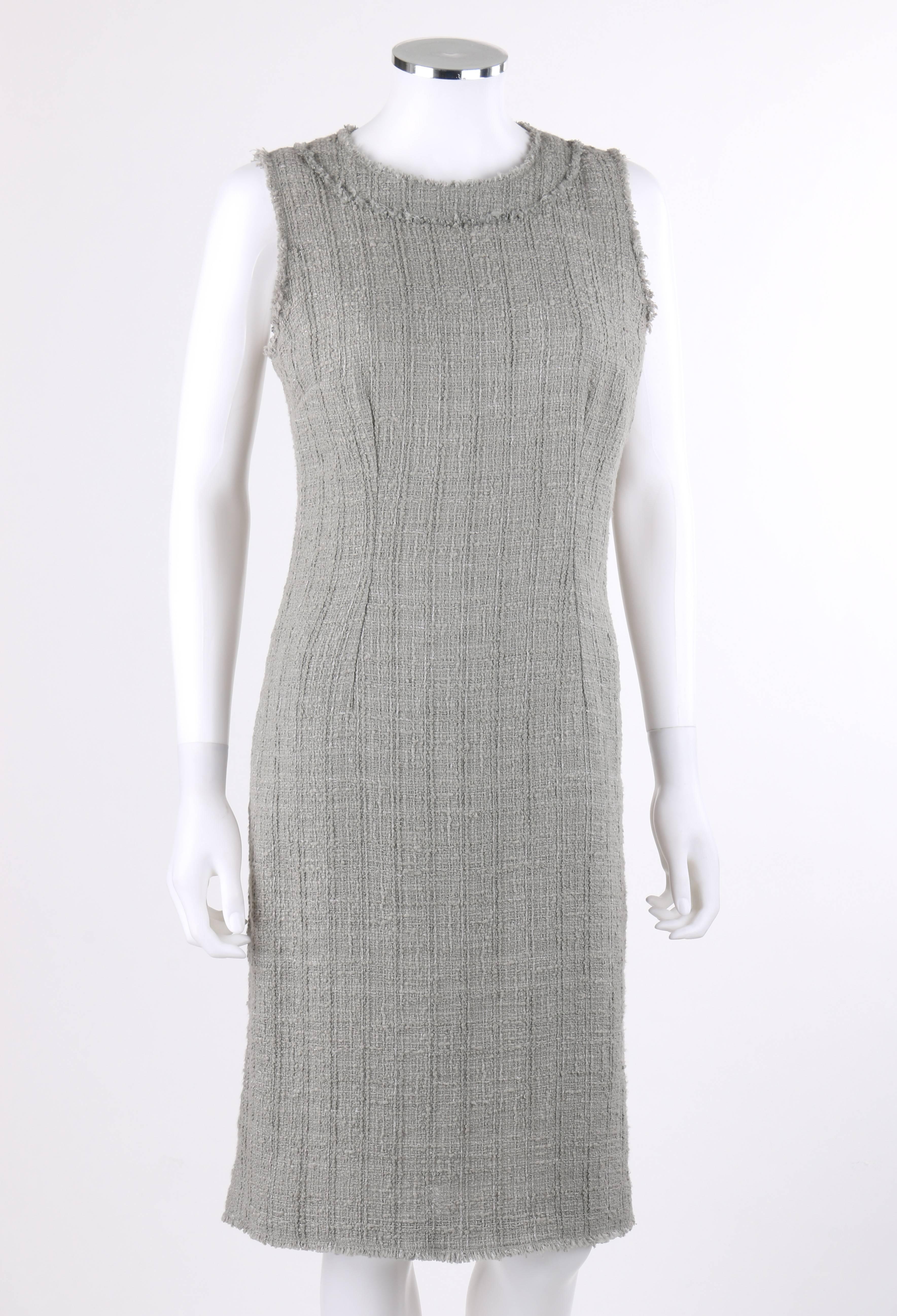 Dolce & Gabbana Autumn/Winter 2008 gray boucle tweed shift dress. Sleeveless shift style. Scoop neckline. Raw edge fringe detail along neckline, arm holes, and hem. Center back lapped zipper with hook and eye closure at top. Center back vent.