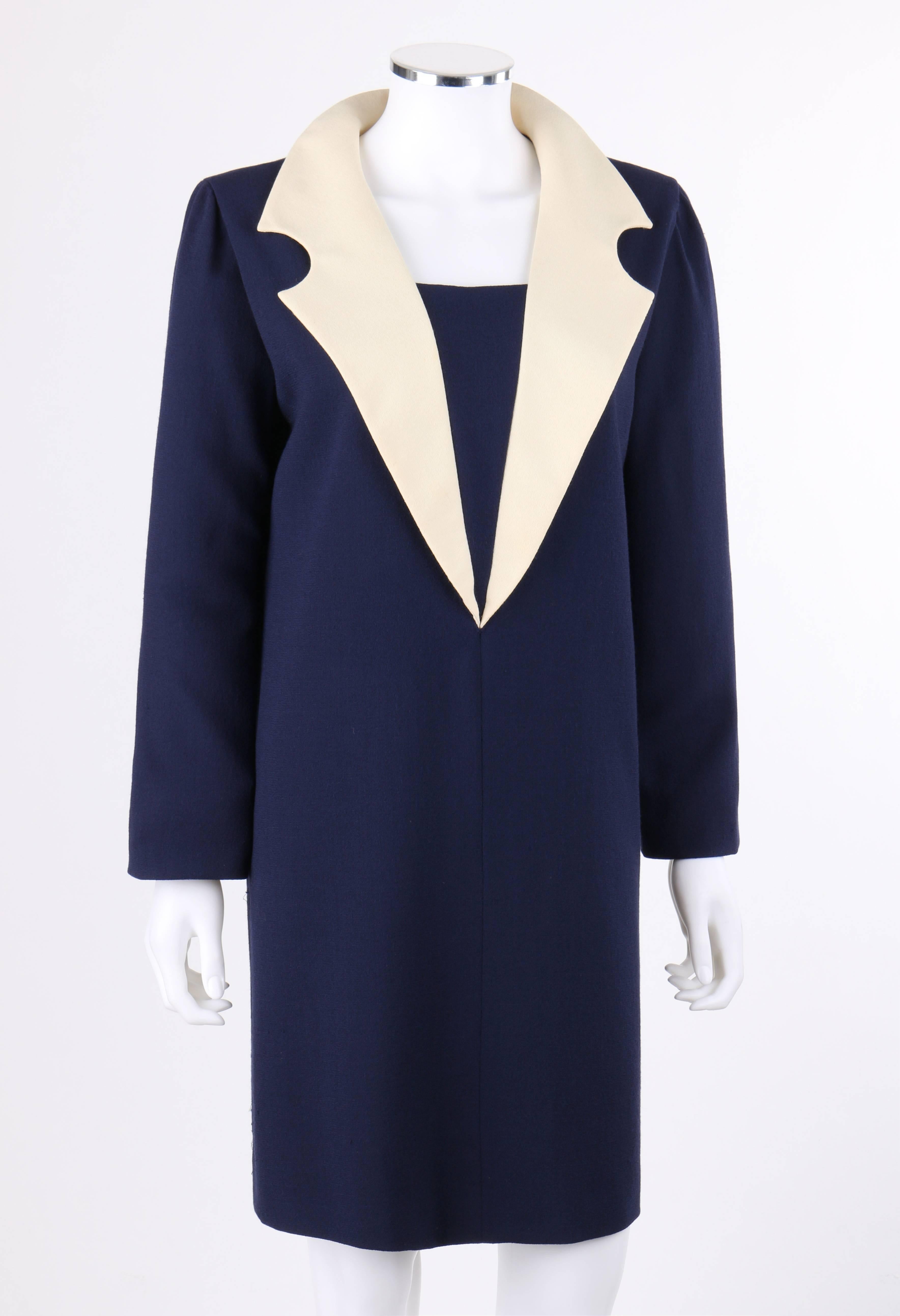 Pierre Cardin c.1992 navy blue and ivory wool statement collar shift dress. Large ivory circular notched lapel collar with center back single snap closure. Center front modesty panel. Long sleeves. Shift style. Center back invisible zipper closure.
