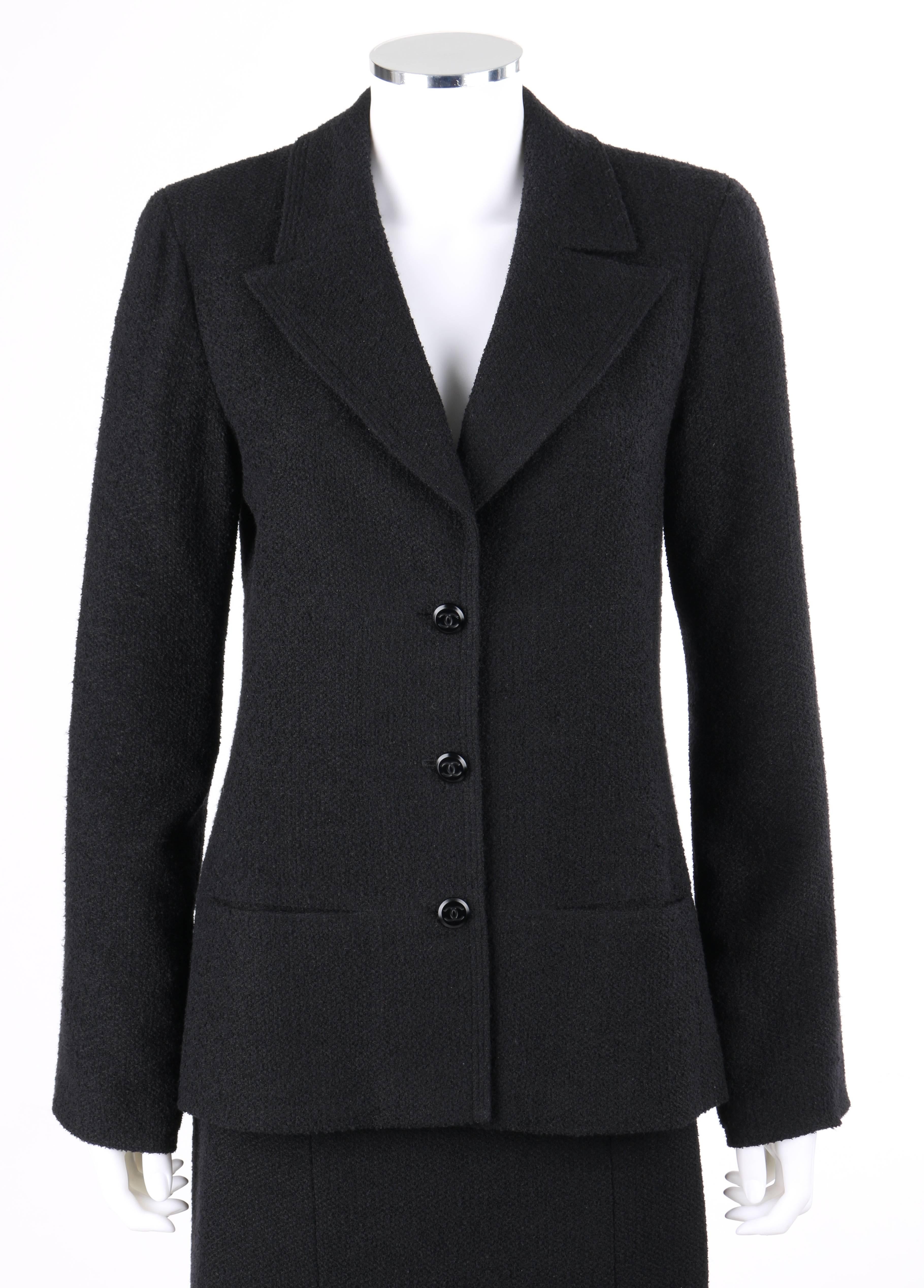 Classic Chanel Autumn/Winter 1998 two-piece black boucle wool skirt suit set. Long sleeve blazer. Notched lapel collar with triple row topstitching. Three center front 