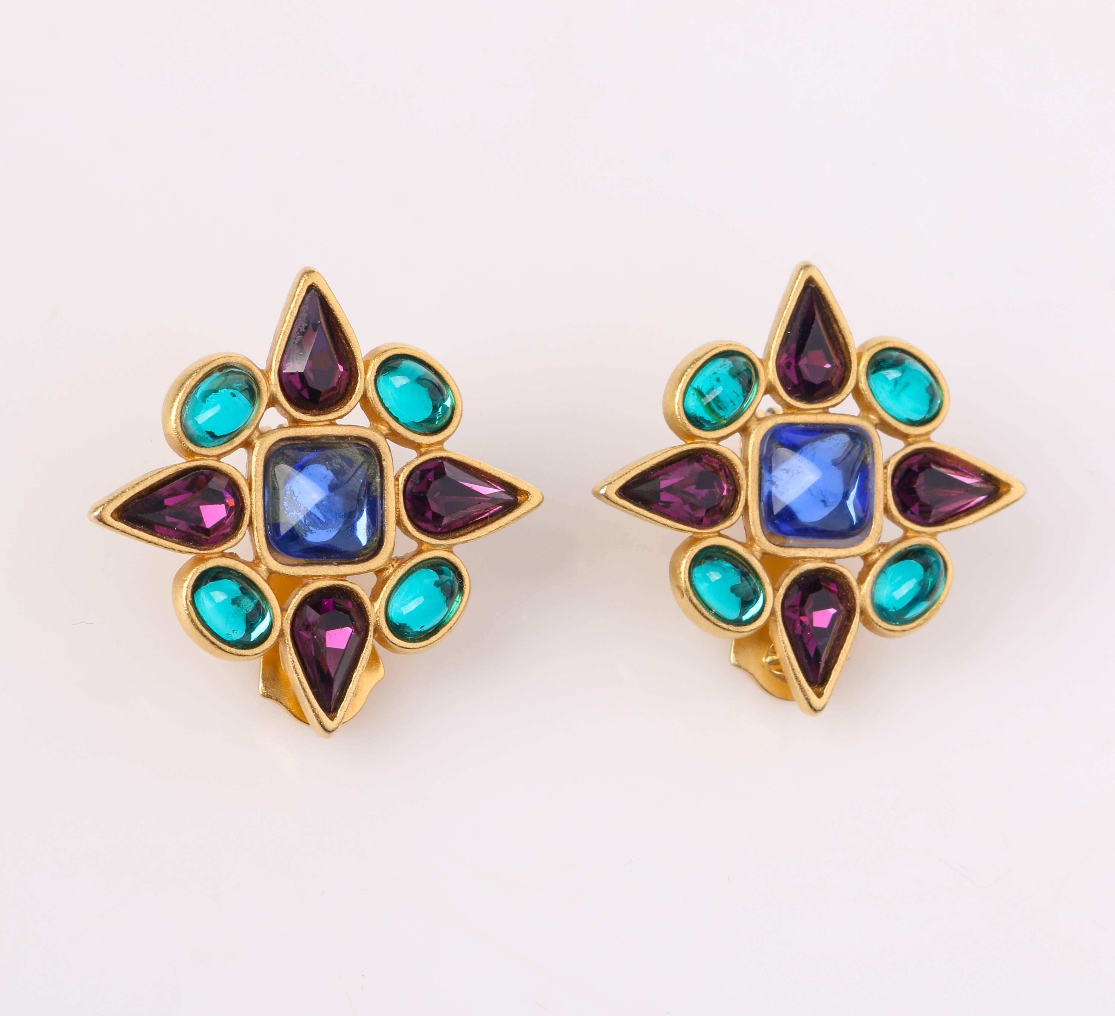 Vintage Yves Saint Laurent c.1980's gold-toned metal and multi-color gripoix (poured glass) clip on earrings. Brushed gold-toned metal setting. Center blue square glass cabochon (7.5mm). Four oval teal glass cabochons (5mm) and four amethyst purple