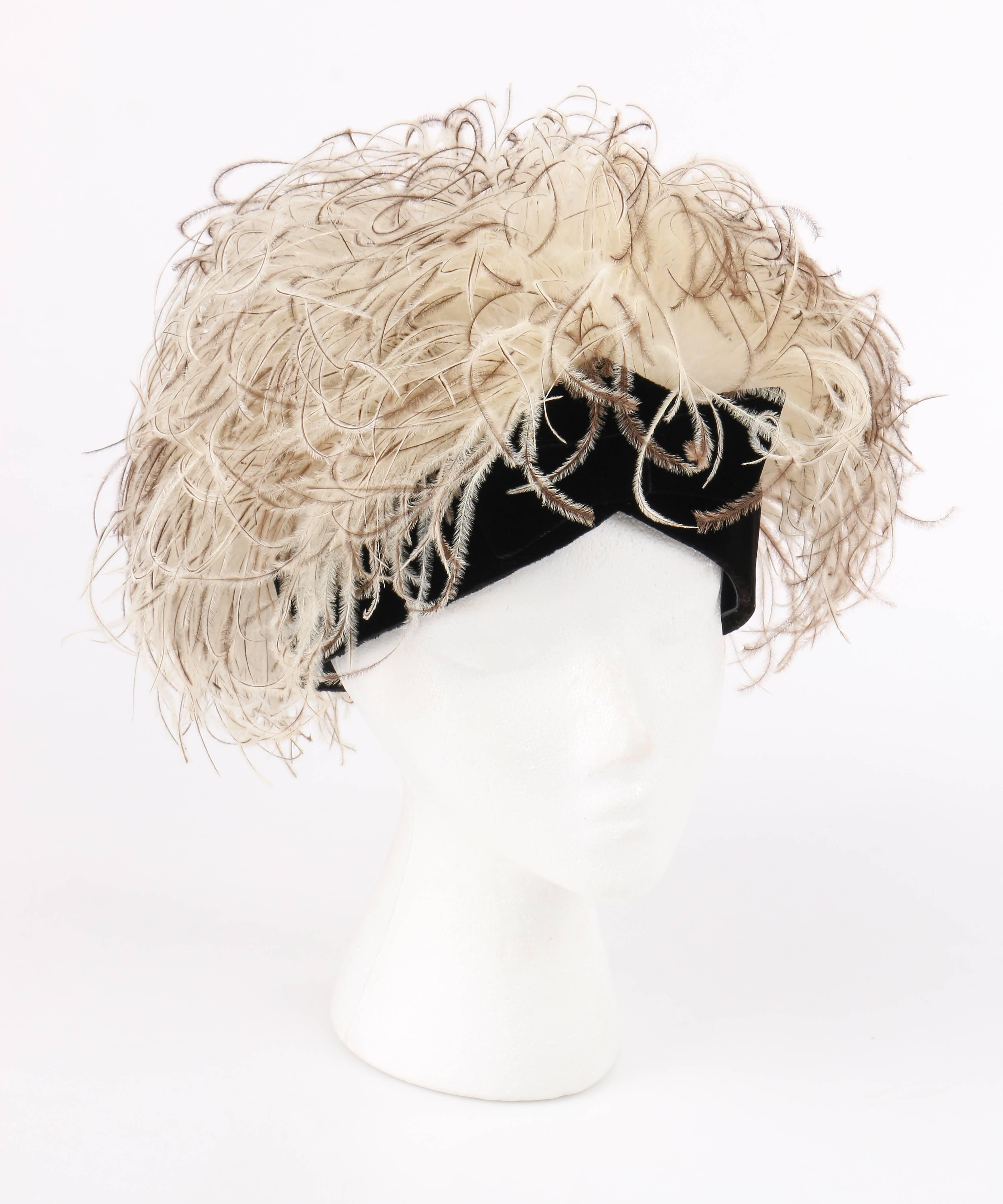 Vintage Jacques Heim c.1960's natural ostrich feather and black silk velvet cocktail hat. Off-white and brown natural ostrich feather wisps attached to a rounded black mesh crown. Thin black silk velvet band with pointed center front and bow.